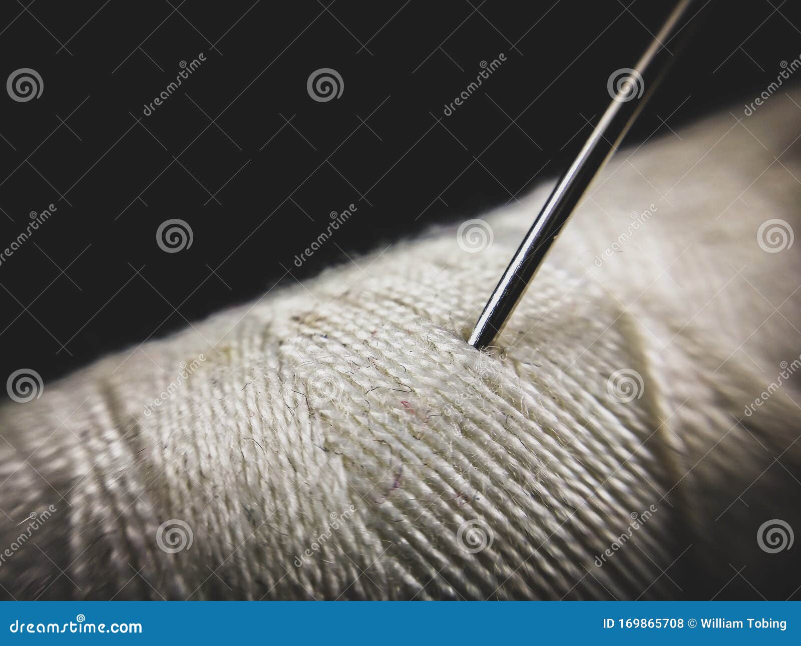 Silver Needle Stick To White Cotton Thread, Close Up Macro Shot Stock