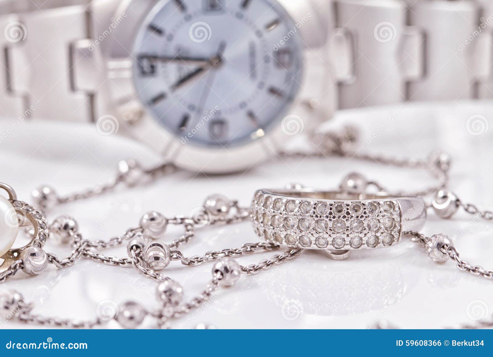 Silver Ring and Chain on the Background of Watches Stock Photo Image