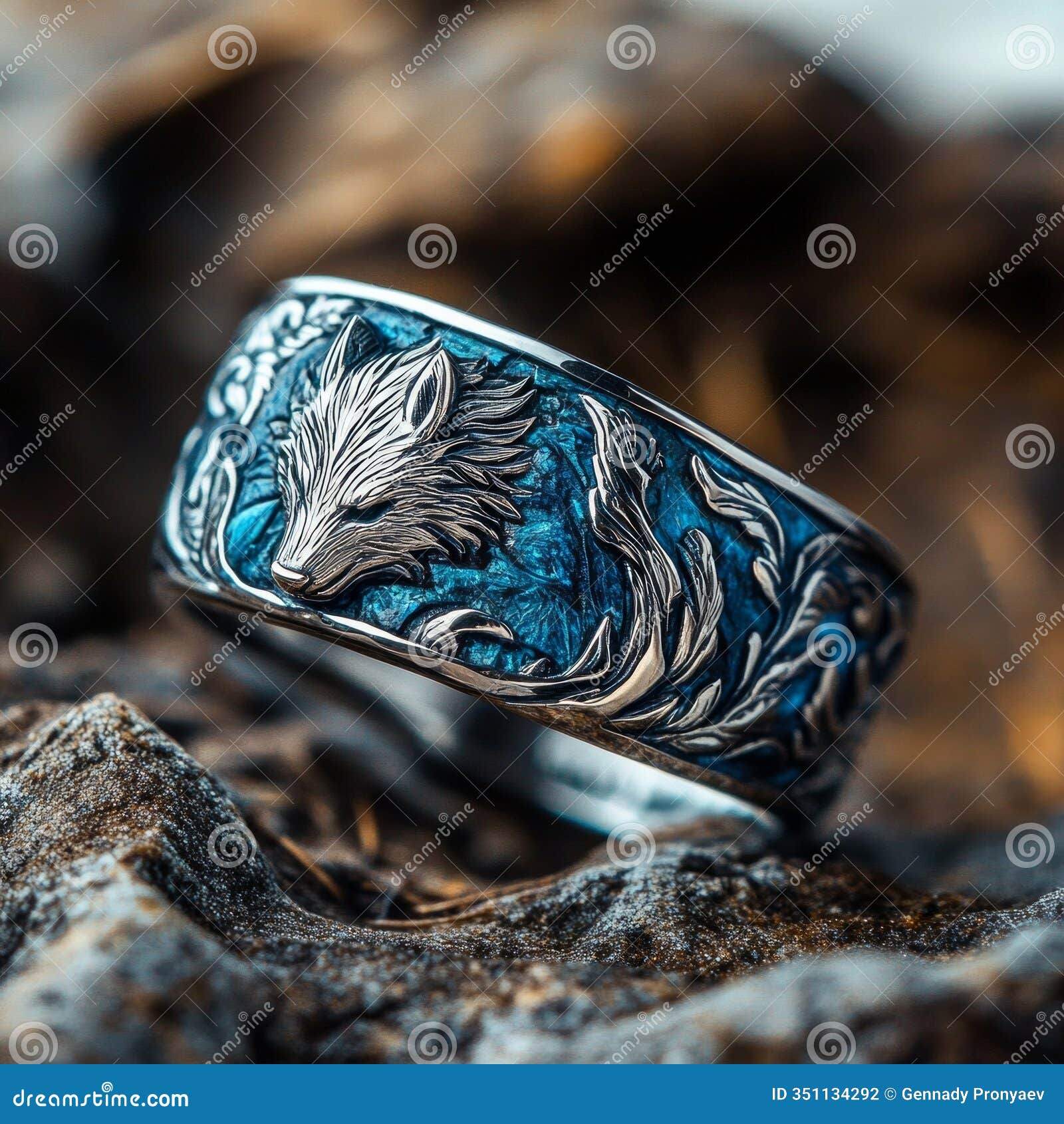 elegant silver ring with wolf  and blue enamel detailing on rock surface