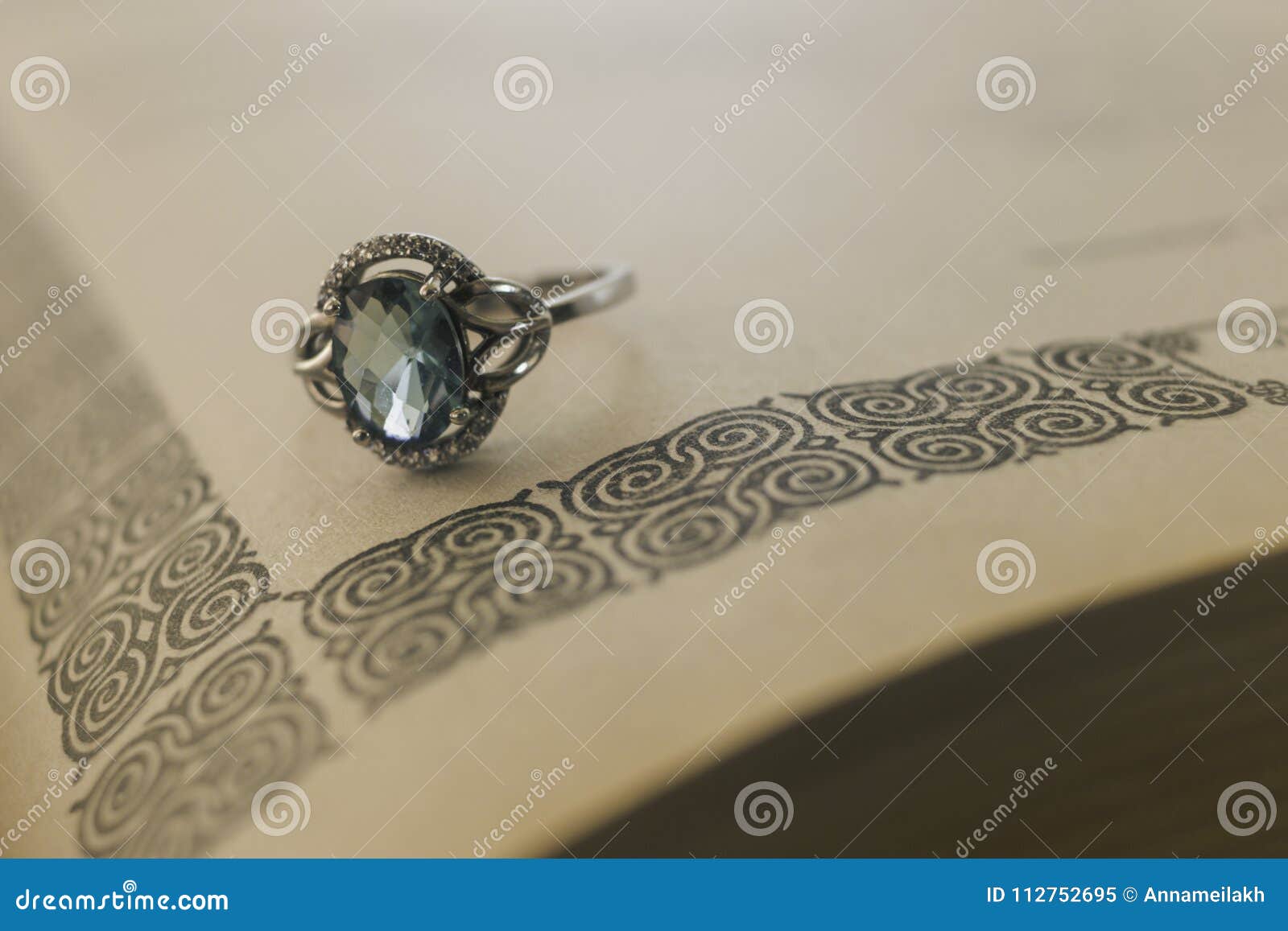 Silver Ring with a Stone on a Book Stock Image - Image of jewerly, book ...