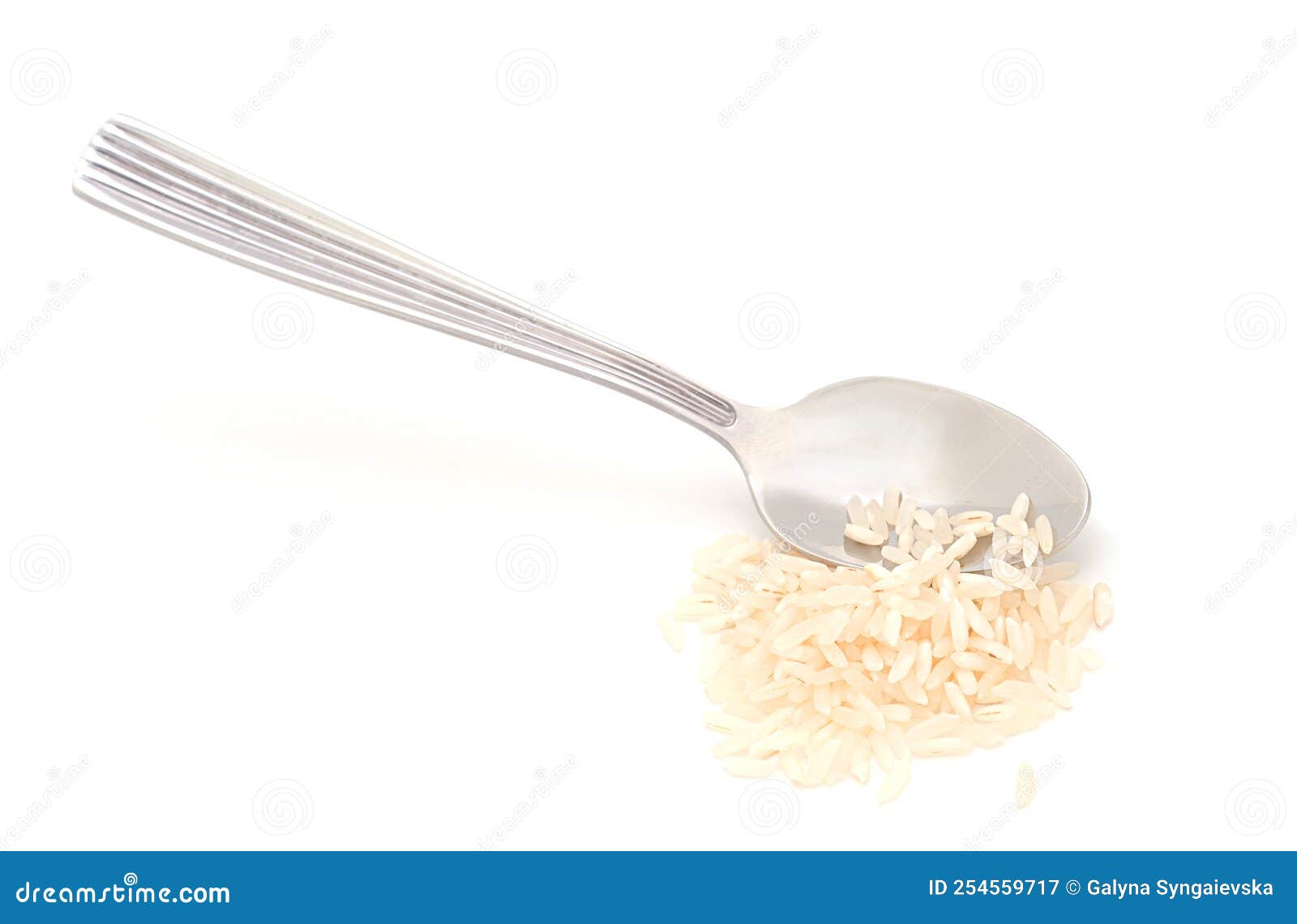 silver spoon and handful of rice