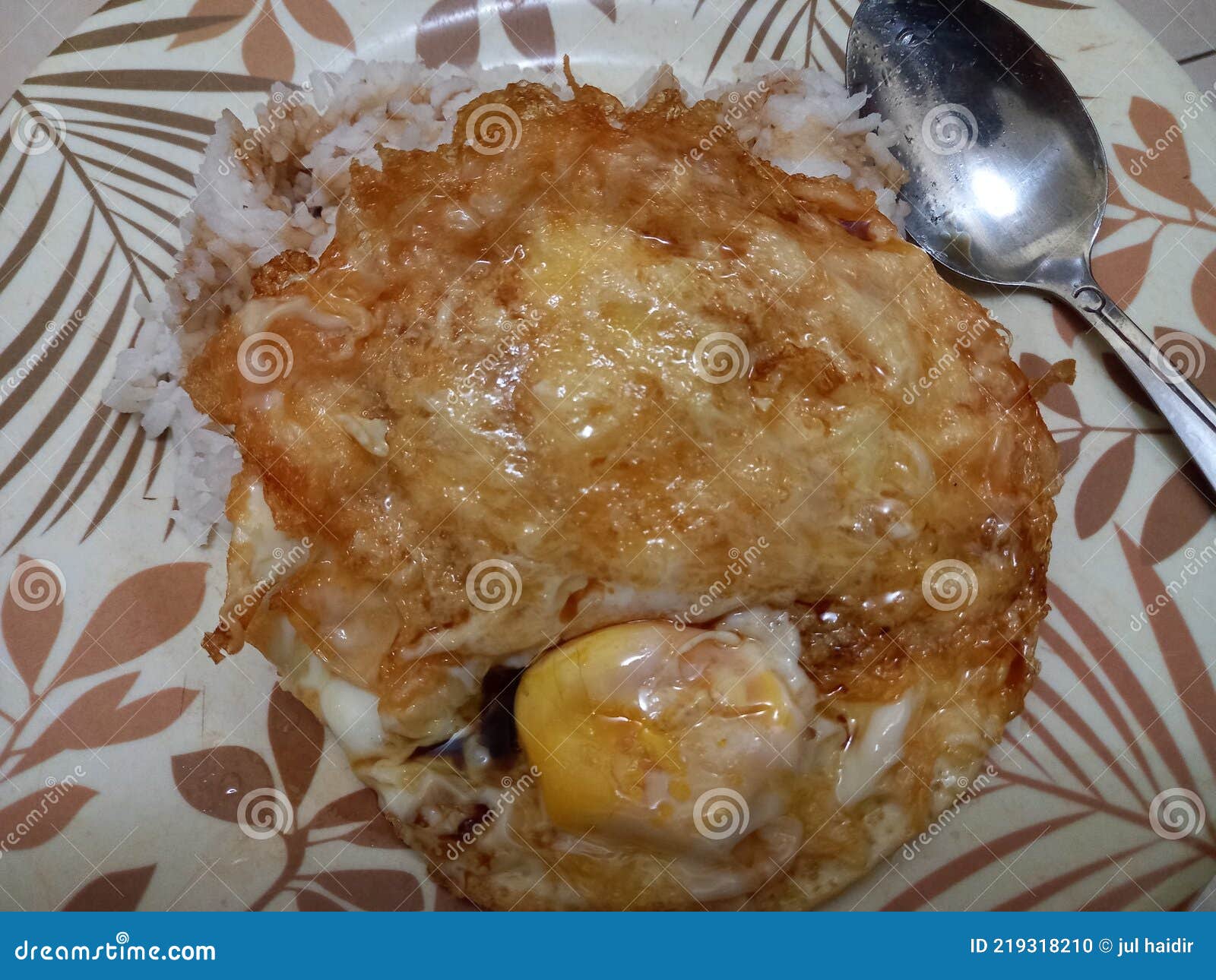 A Simple Breakfast Consisting of Fried Egg, White Rice and Soy Sauce