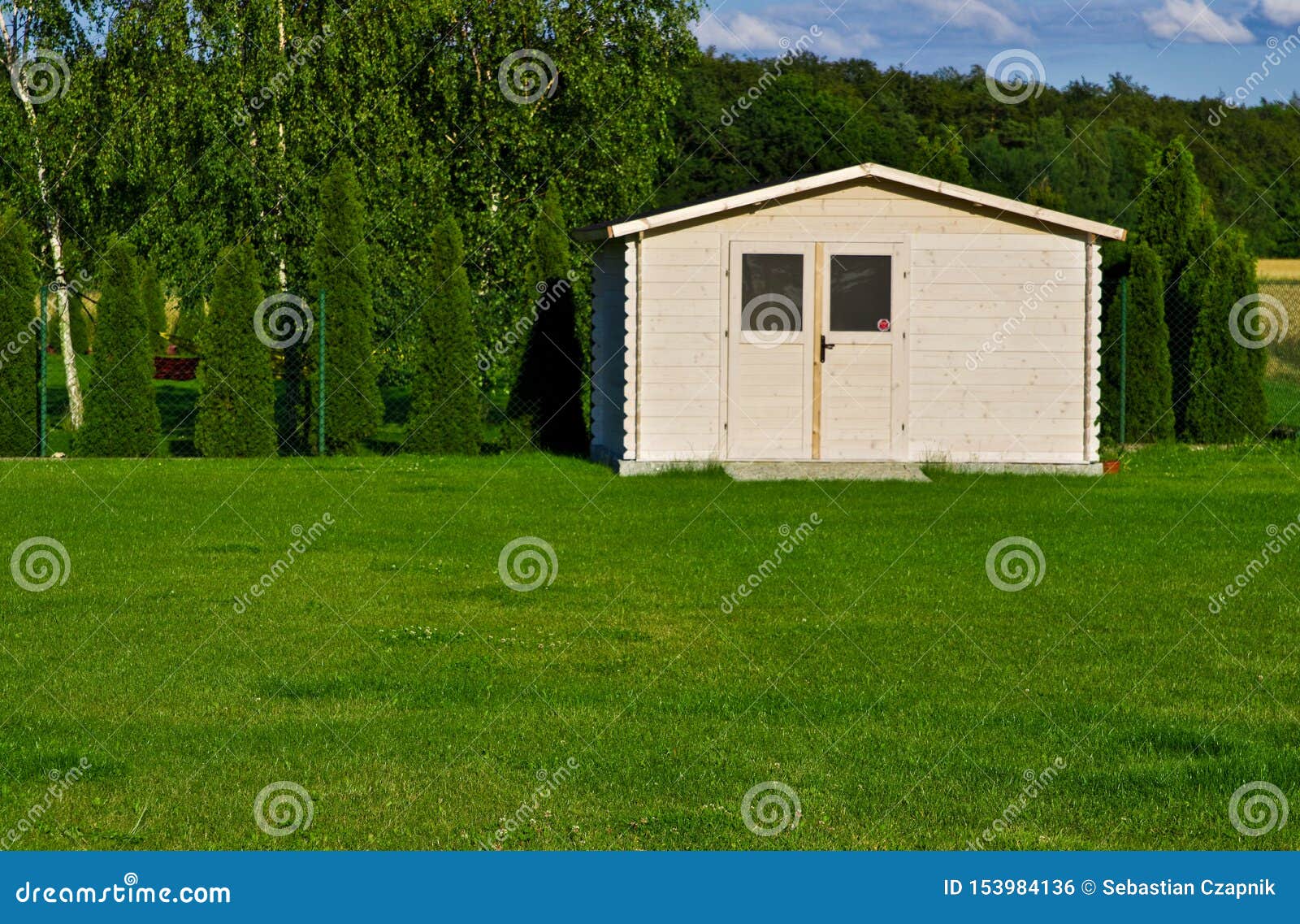 new garden house or shed in green lawn or grass
