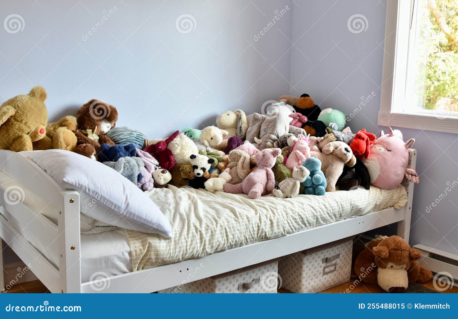young kids room with cute plush toys on bed and simple, easy storage baskets underneath