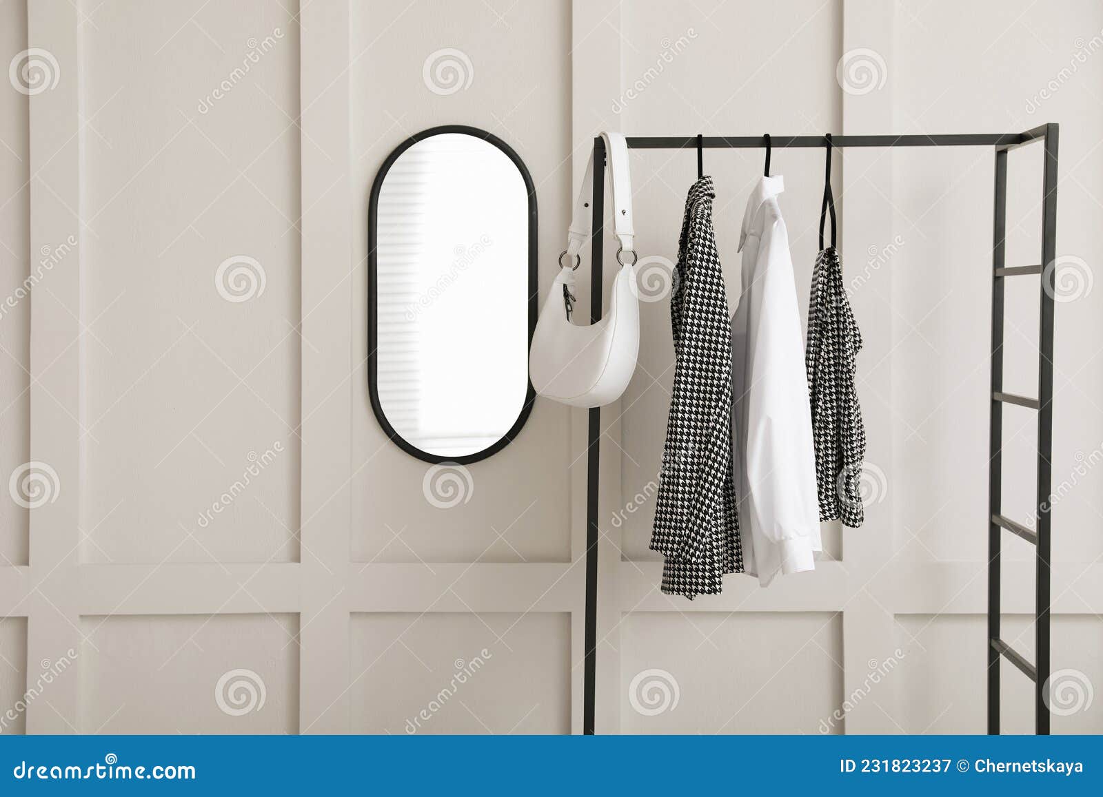 Simple Hallway Interior with Clothing Rack and Mirror on Light Textured