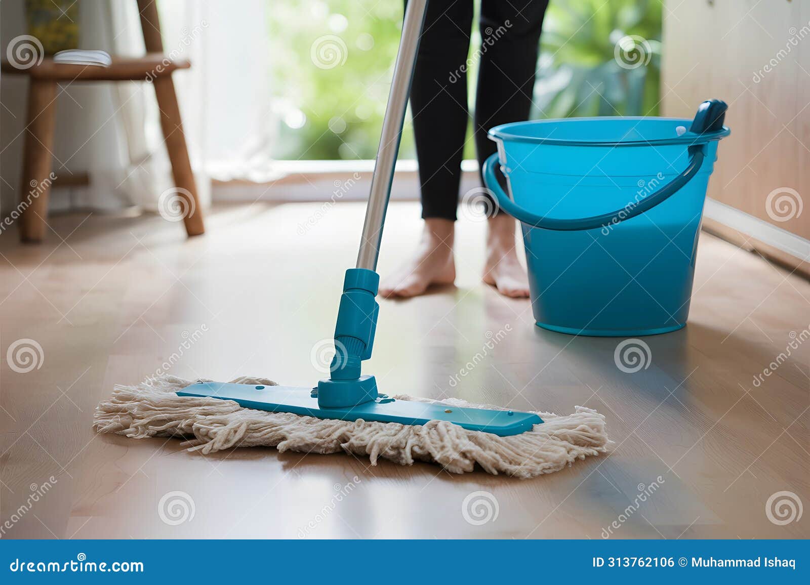 simple mop on laminate floor with water bucket in background