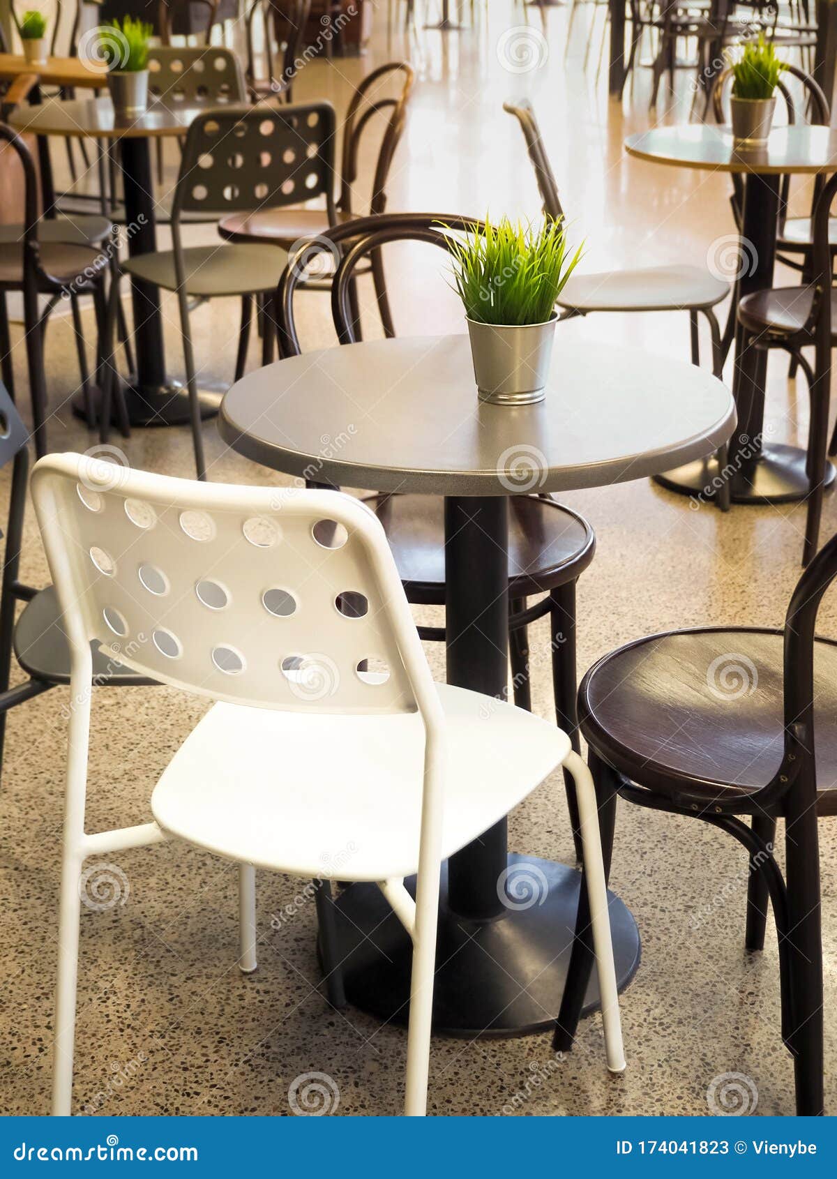 Simple Retro Style Coffee Shop Interior with White and Black Chairs