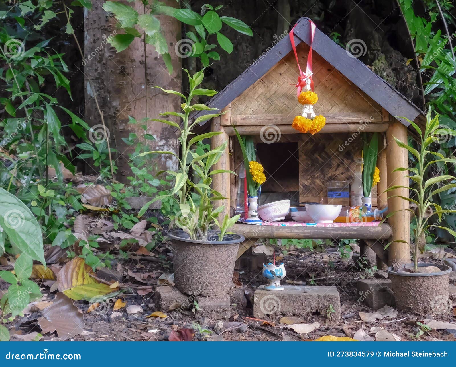simple spirit house in a temple yard