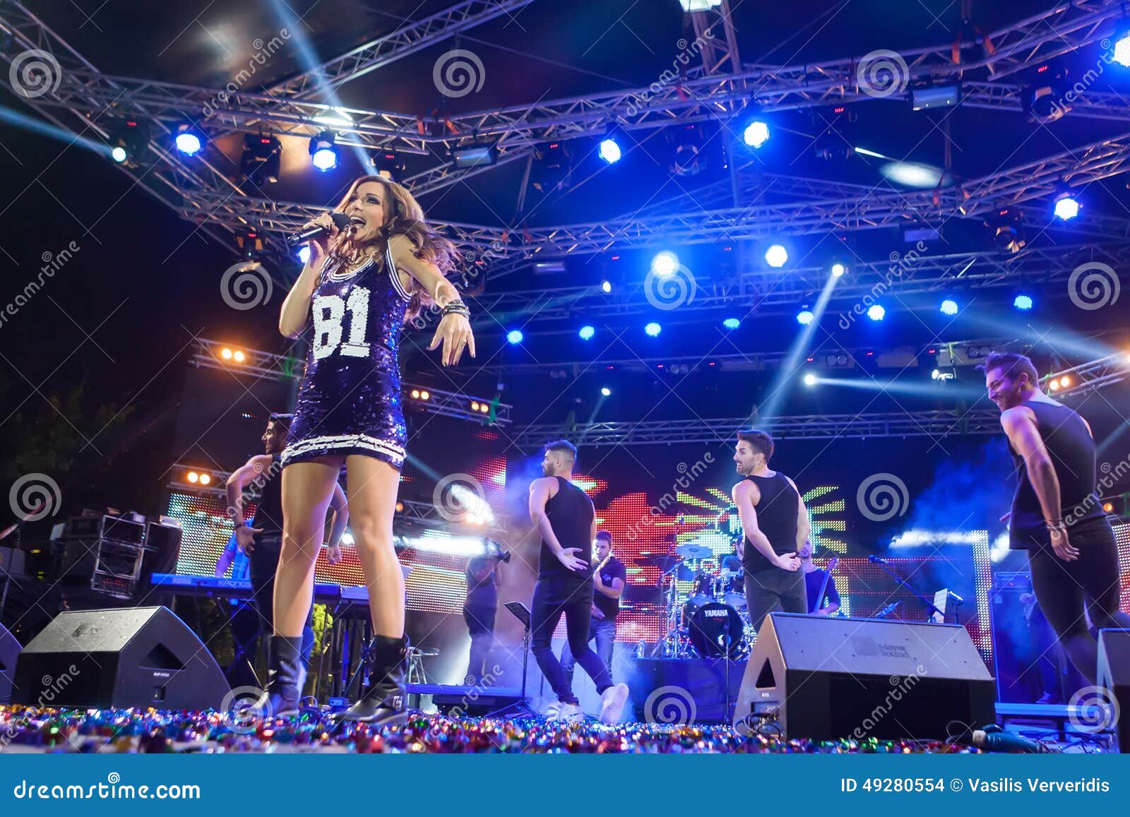 THESSALONIKI, GREECE, SEPTEMBER 11, 2014: Singer Despina Vandi performing at MAD North Stage festival by Thessaloniki International Fair. Blur stage spotlights with laser rays in the background.