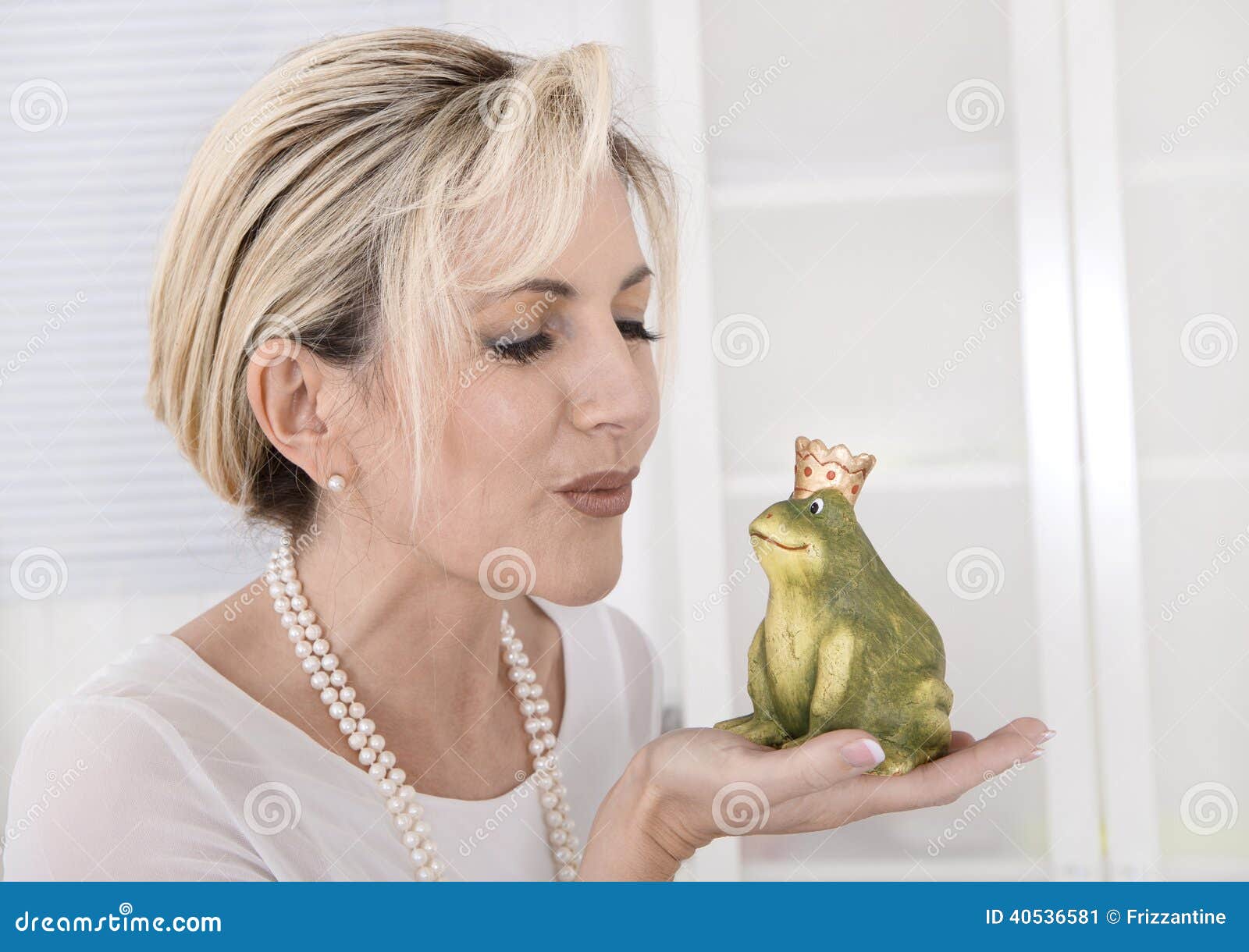 single attractive older woman with a frog king in her hands.