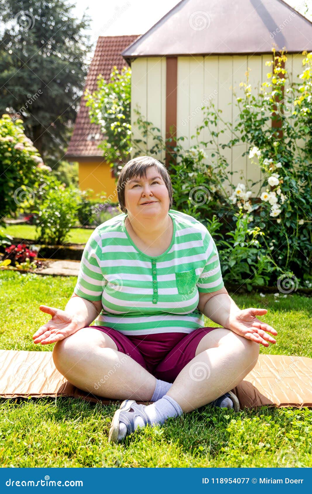 single mentally disabled woman is doing some relaxation yoga exercises