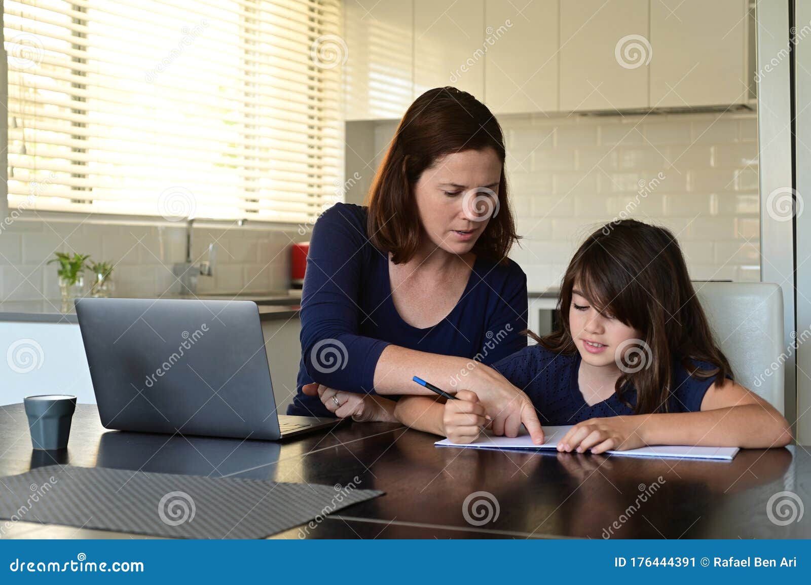 single mother and daughter at home as the pandemic coronavirus covid-19 forces many employees and students to work and study