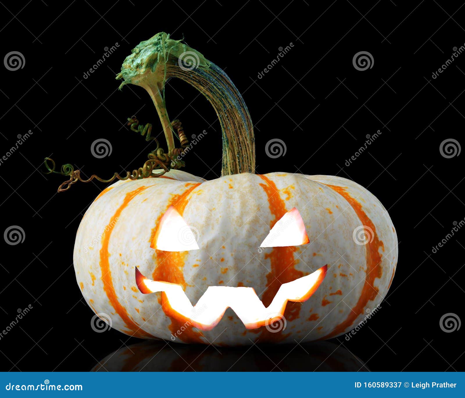 single orange striped pumpkin jack-o-lantern on black