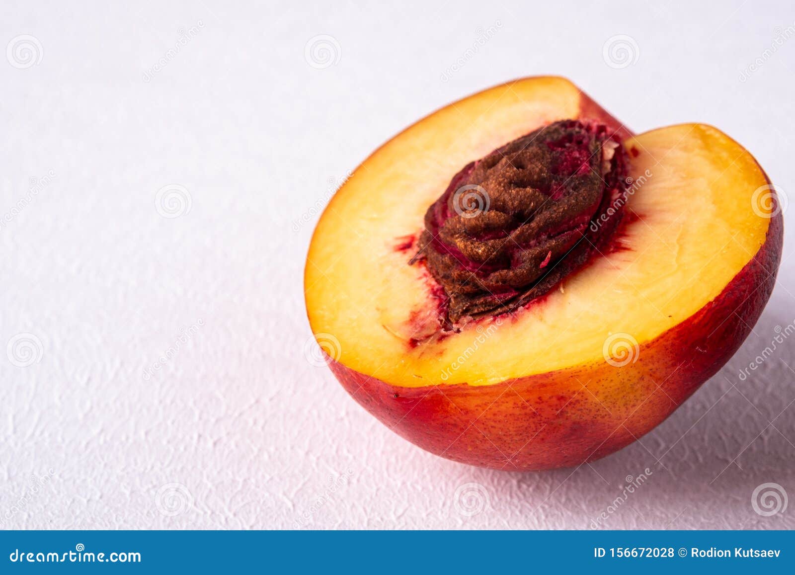 Single Slice of Peach Nectarine Fruit with Seed on White Background