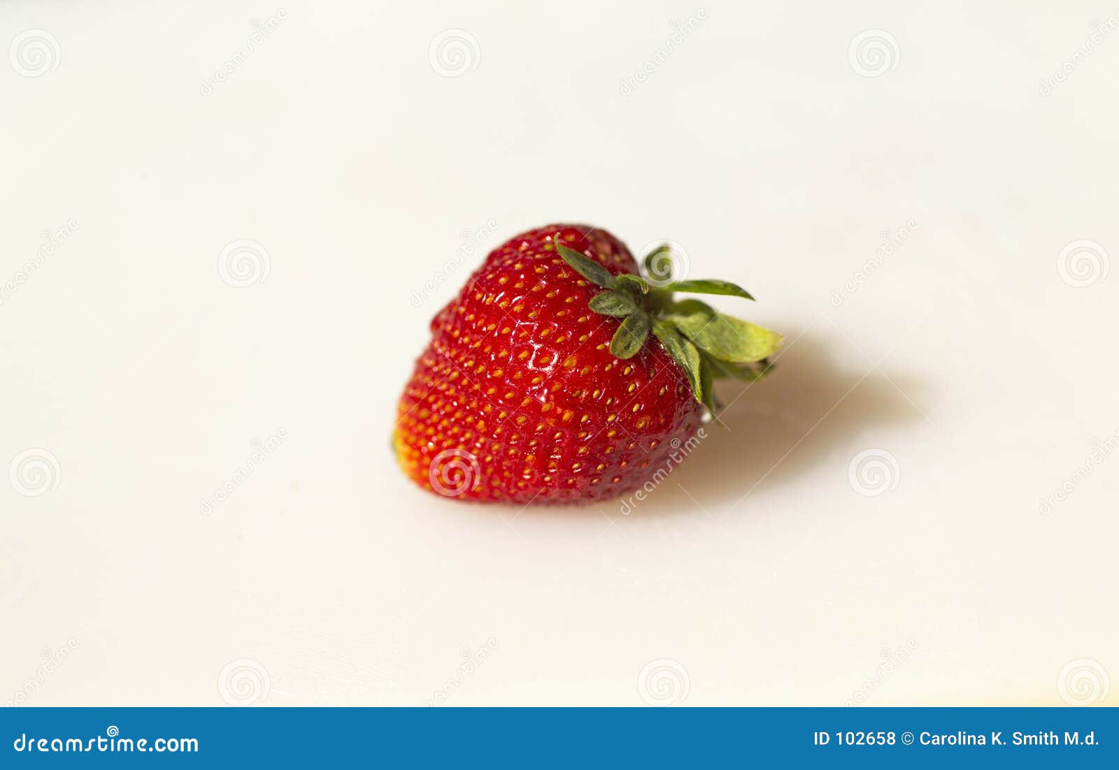 single strawberry on white