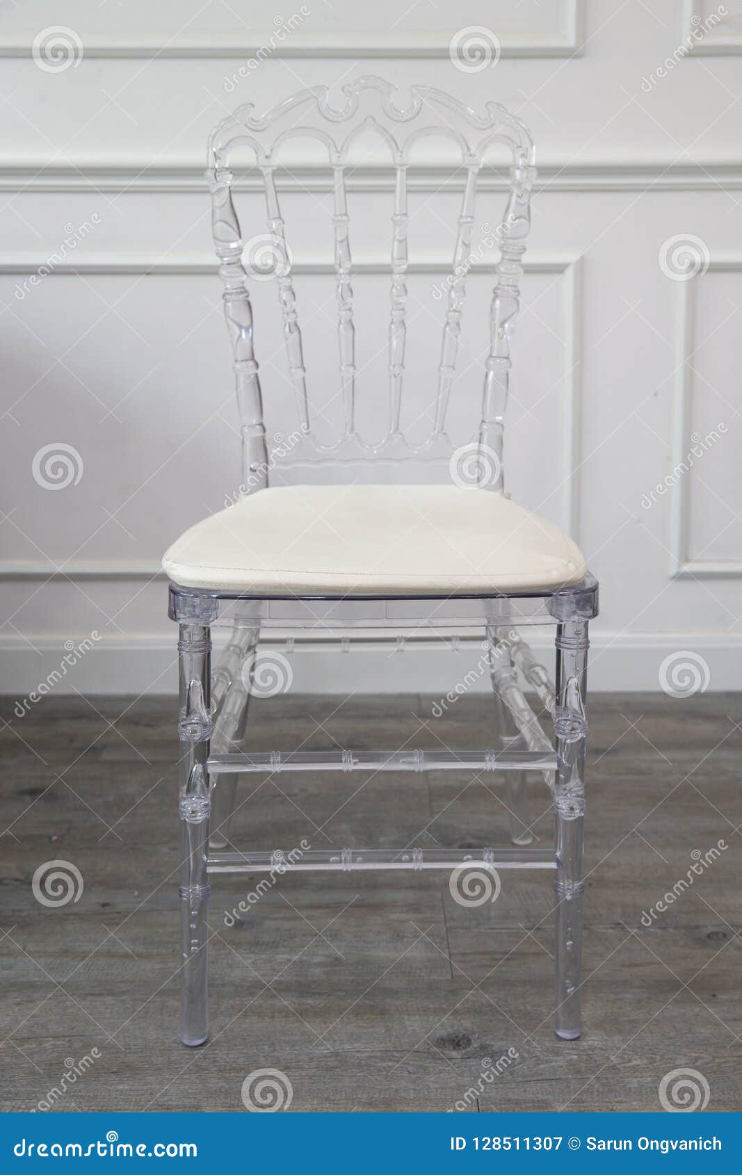 Single Transparent Chair With Leather White Pad On Wooden Floor