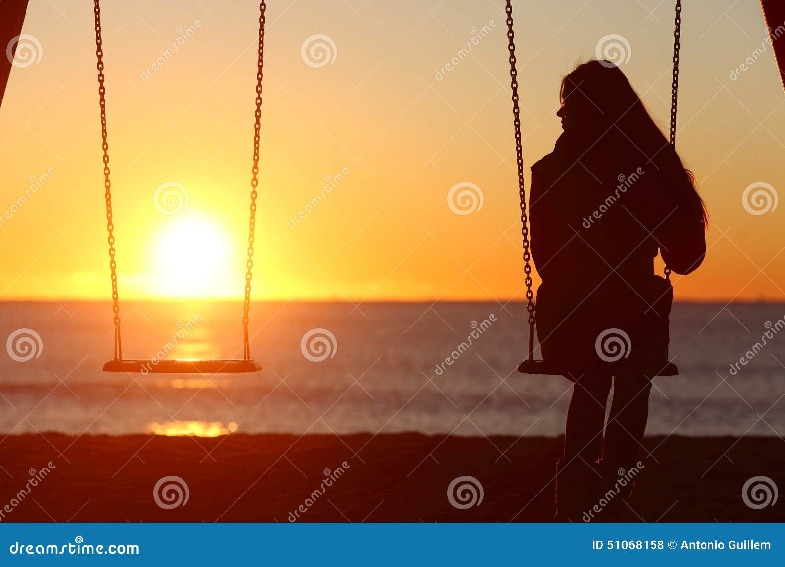 single woman alone swinging on the beach