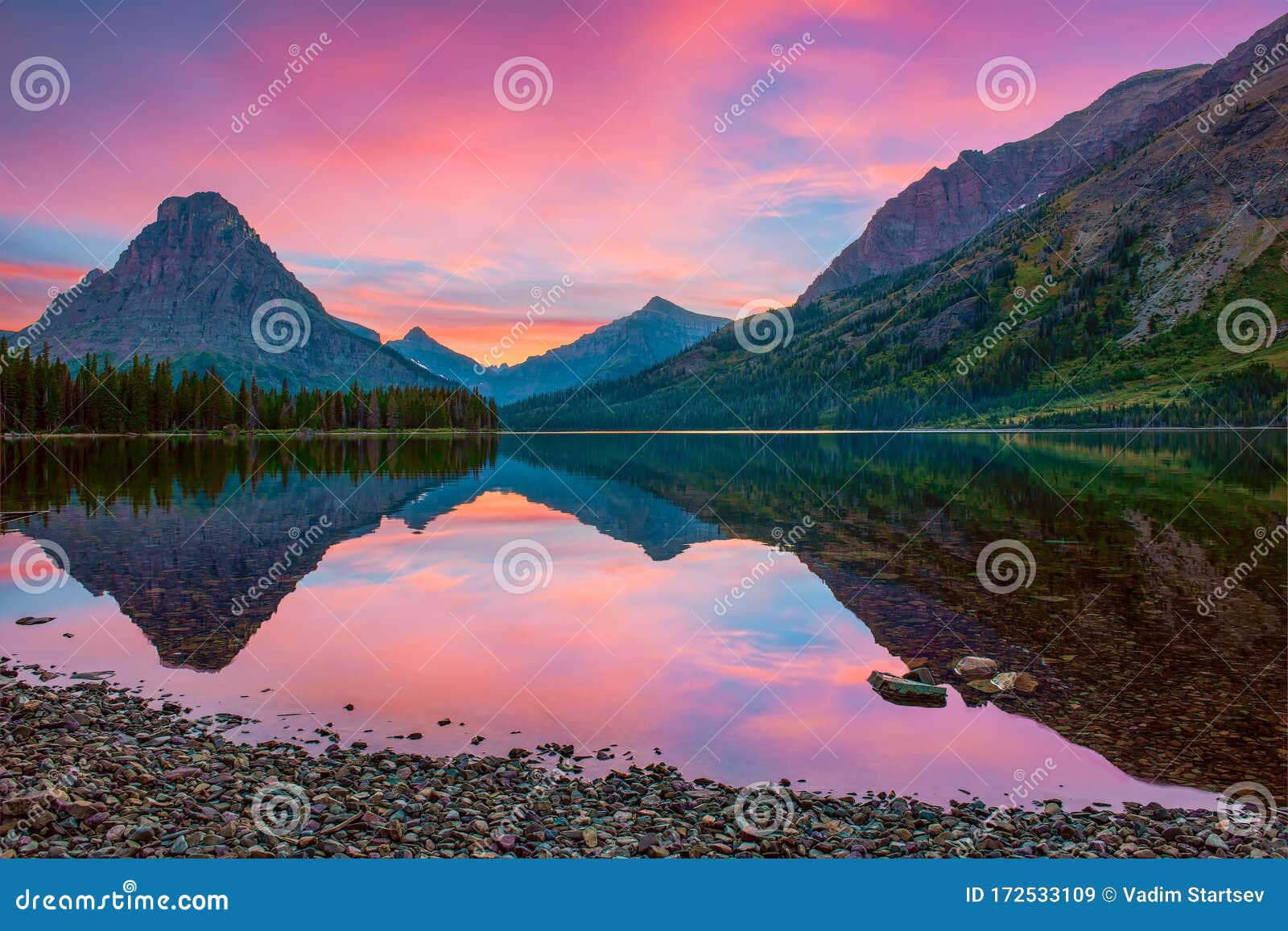 sinopah mountain and its reflection in two medicine lake.glacier national park.montana.usa