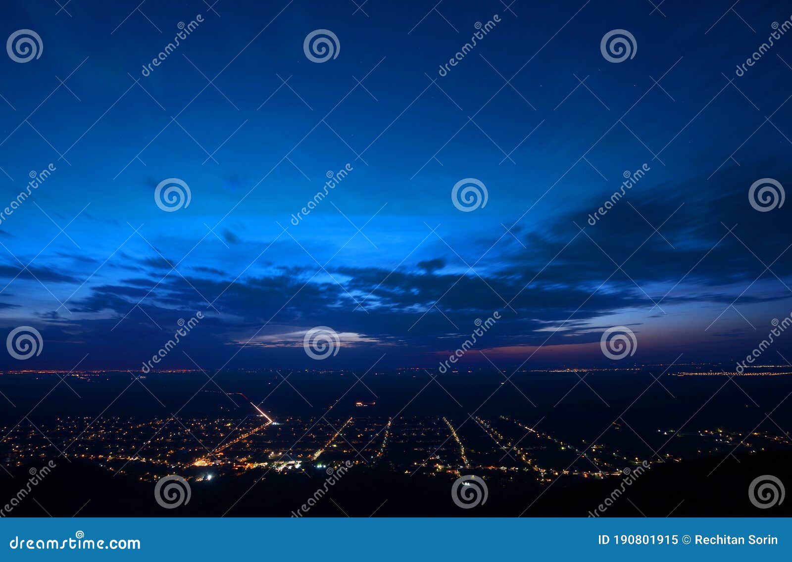 siria village seen from the siria fortress at night. the bright lights of the city arad in the background.