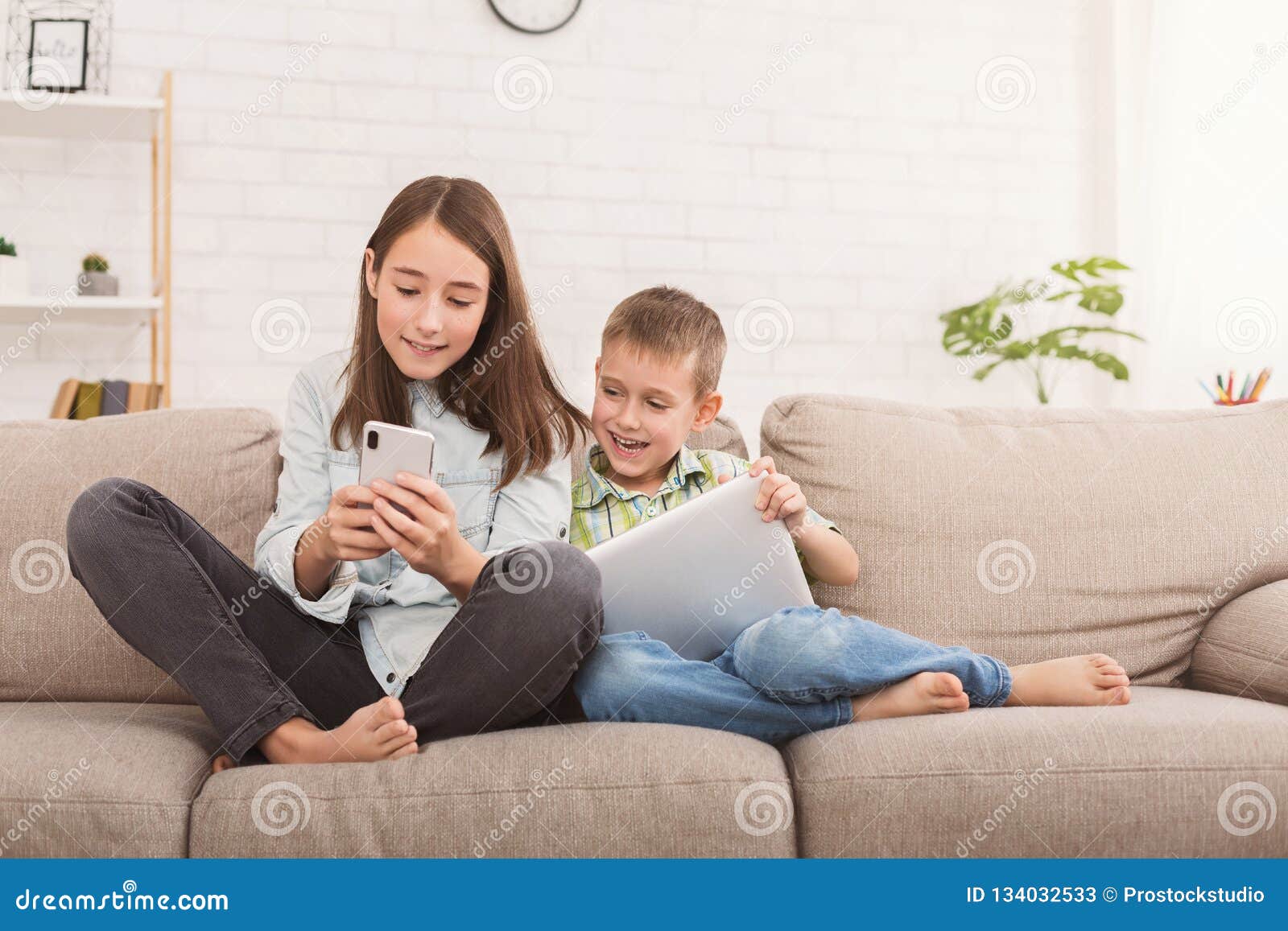 Sister and Brother Sharing Funny Content on Gadgets Stock Image - Image