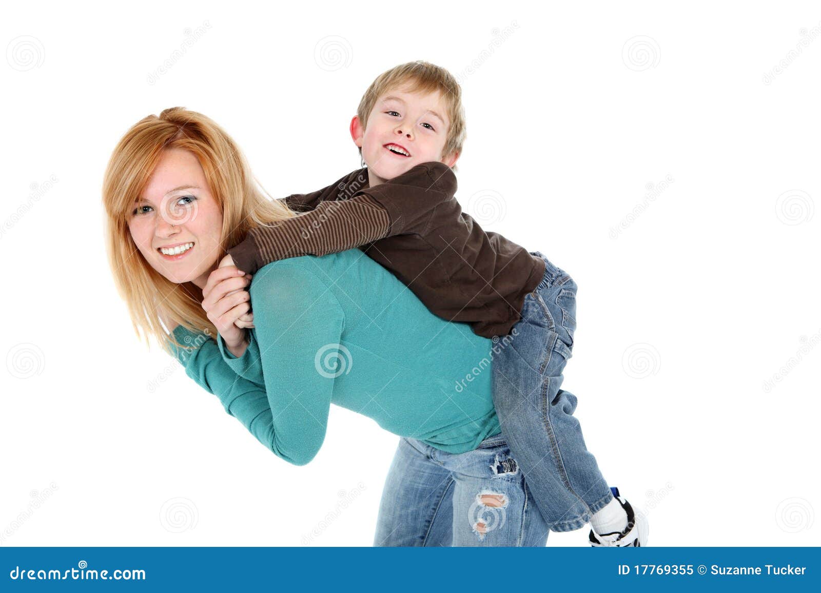 Young girl carrying sister giving piggyback ride Stock Photo