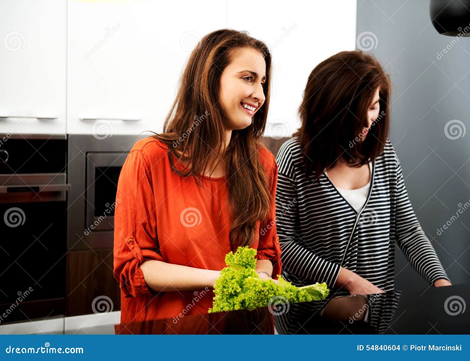 Sisters Cooking Meal Together. Stock Photo Image of recipe, indoors