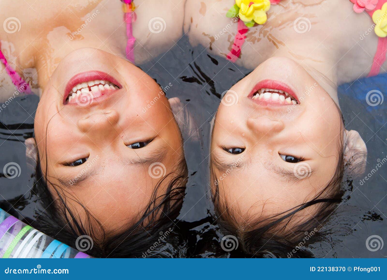 sisters at a wading pool