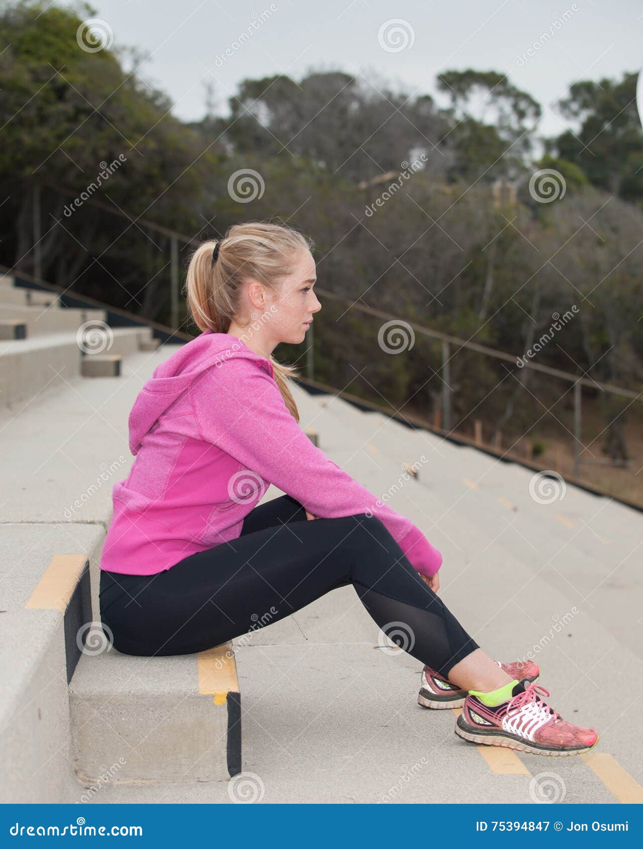 Sitting on Bleachers in Pink Jacket Stock Image Image of steps, woman