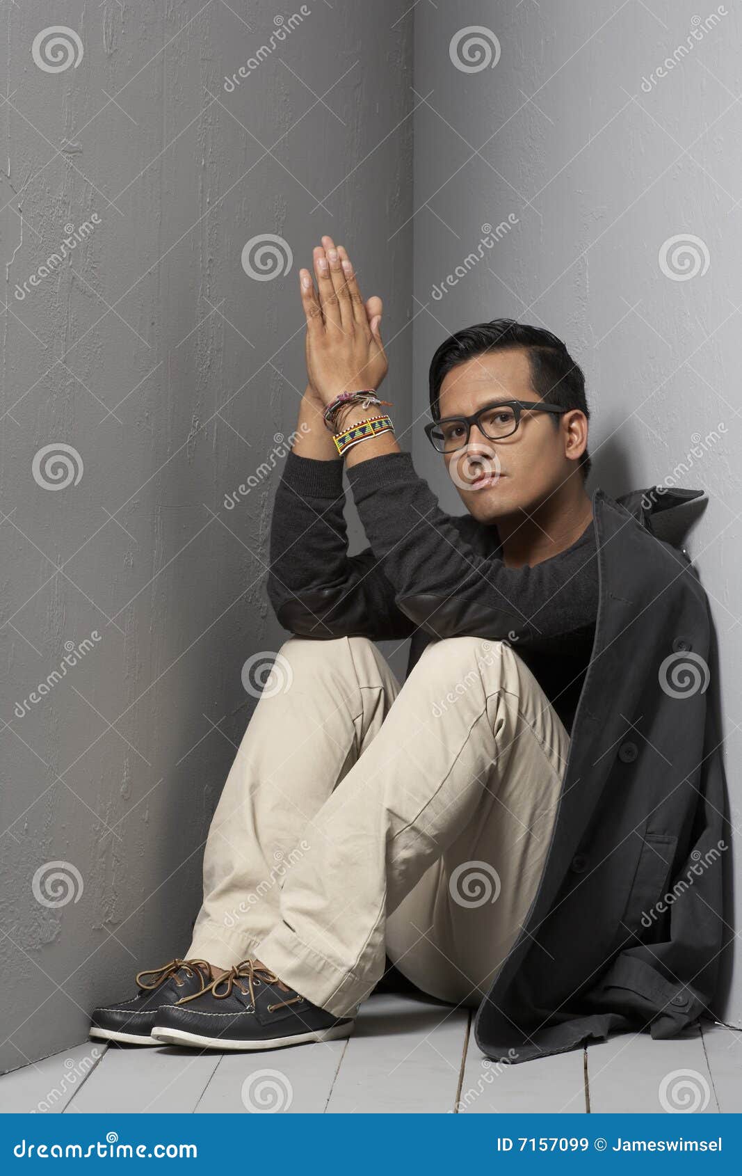 Sitting with hand together stock image. Image of khaki 7157099