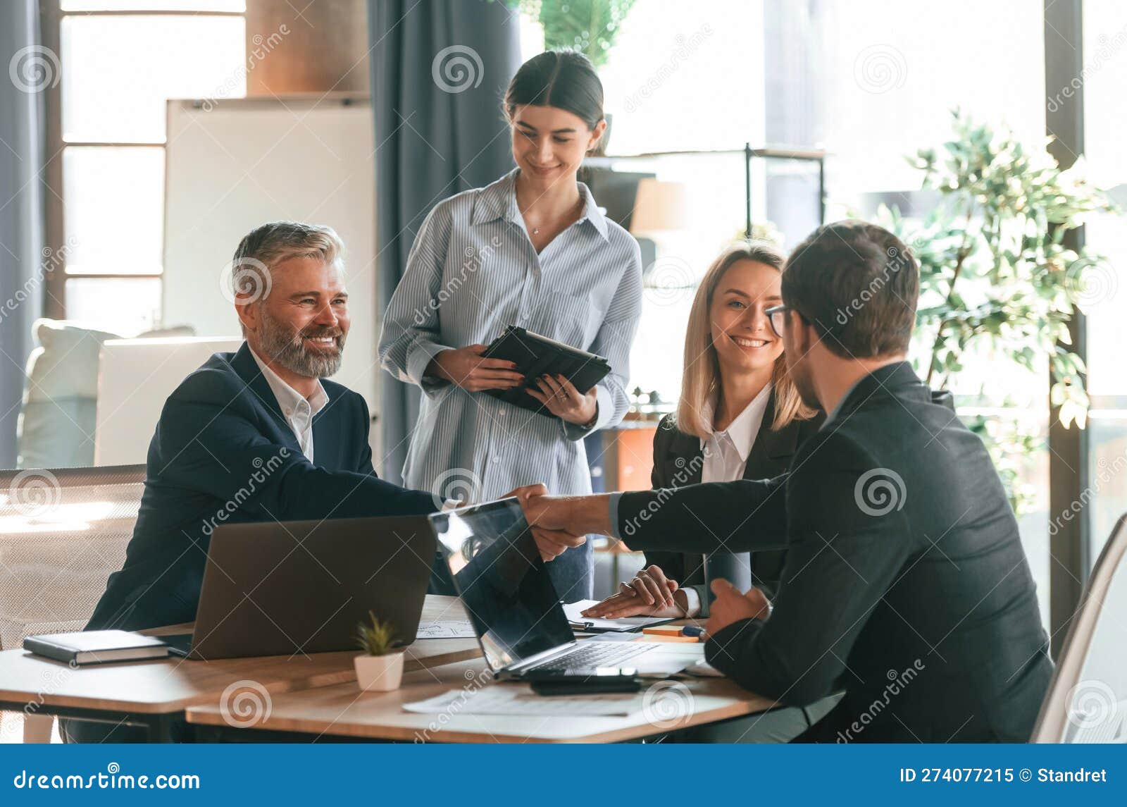 Sitting by the Table. Group of Business People are Working in the