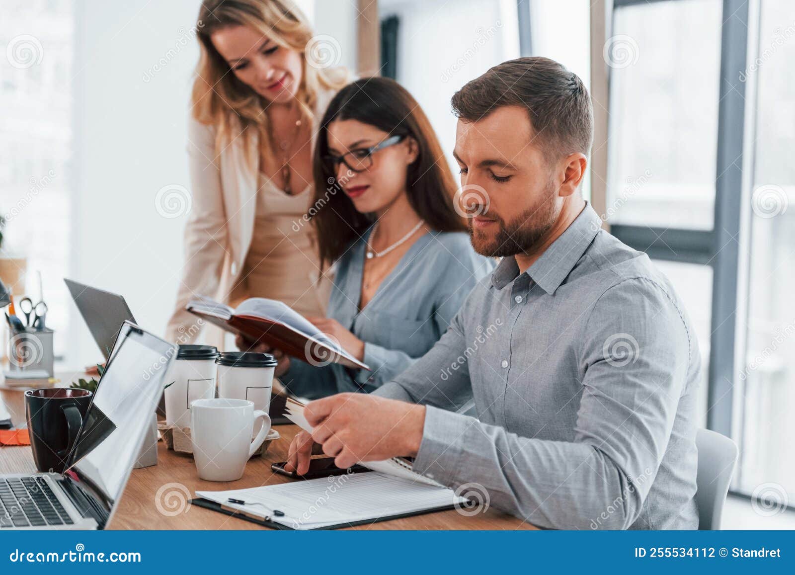 Sitting by the Table. Group of Business People that Working on the