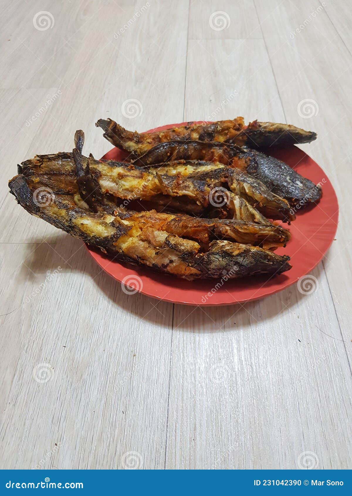 This is Six Fried Catfish Placed in a Red Plate, this Catfish is Non