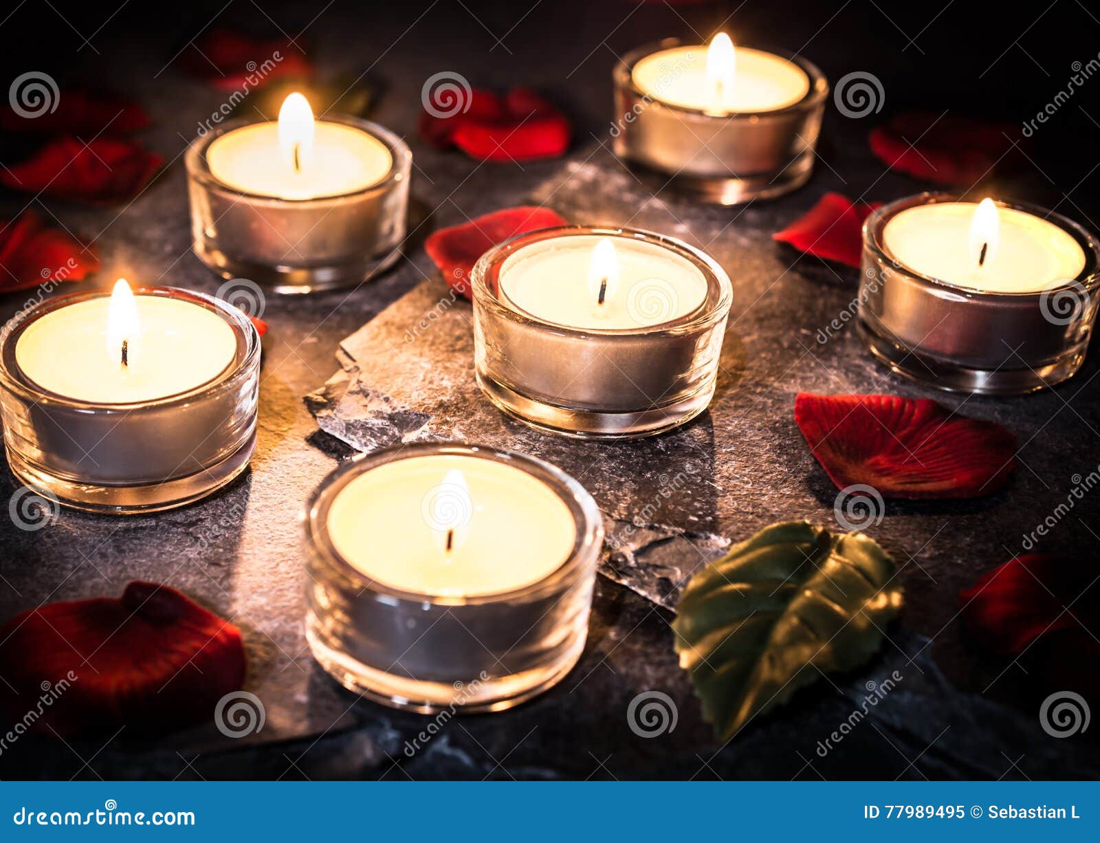 Six Romantic Tea Lights on Slate with Rose Petals and Leafs Stock Image