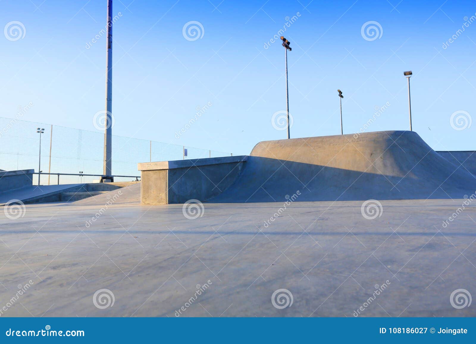 skate park generic concrete ramps outside with blue sky