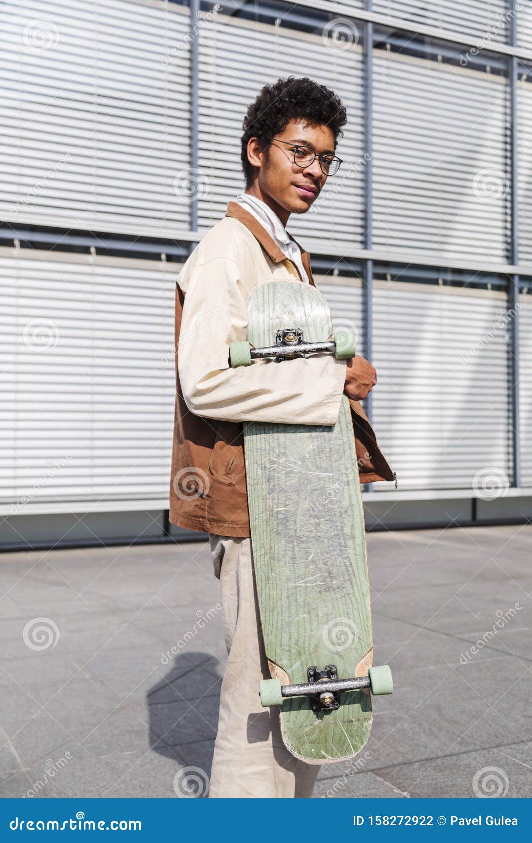 Skateboarder Stands with His Skateboard in City Stock Photo - Image of ...