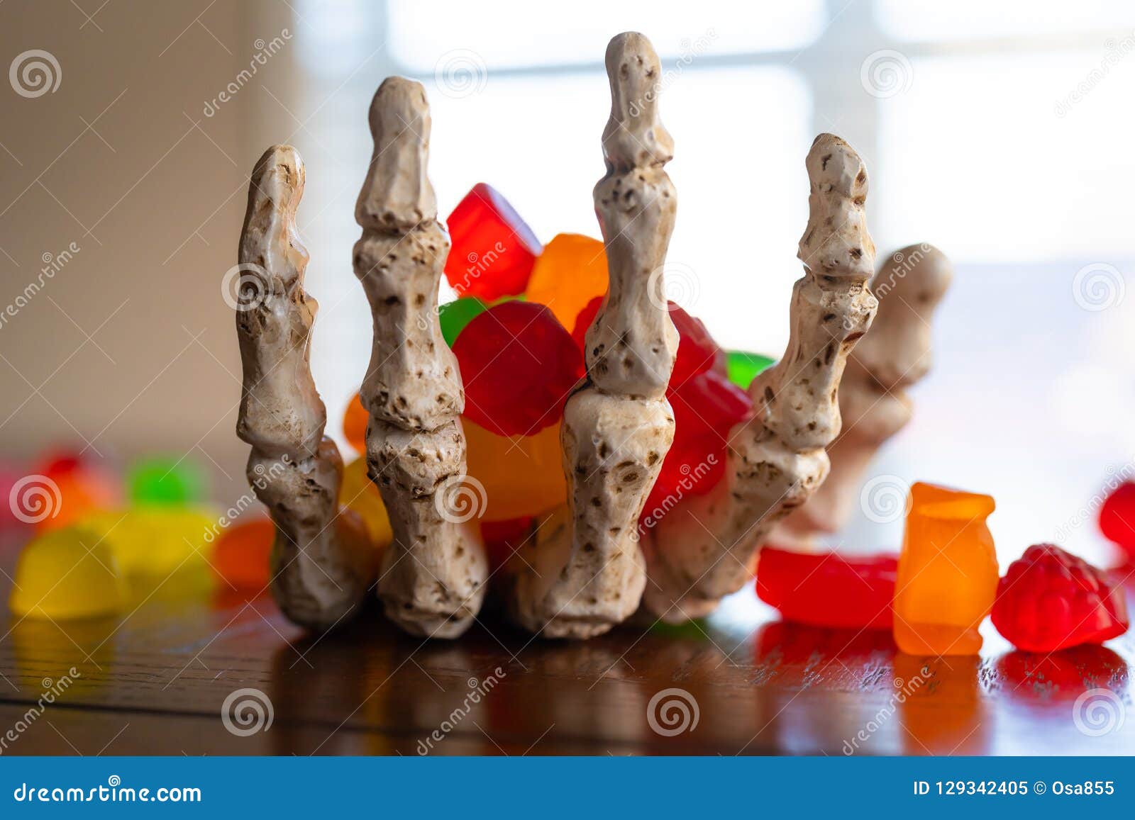 Skeleton Hand Offering Bowl of Candy during Halloween Stock Image