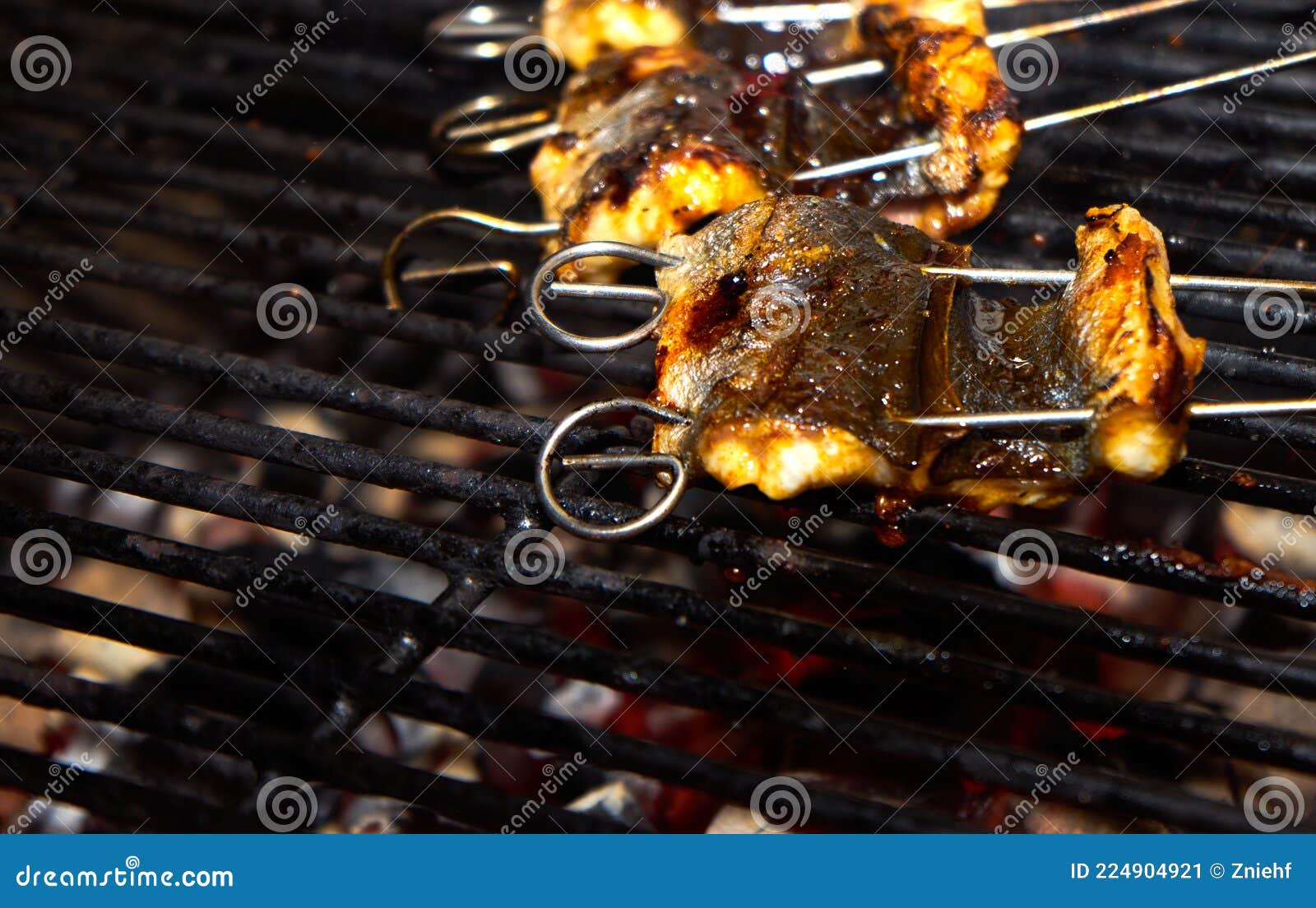Skewered Pieces of Fresh Japanese Marinated Eel on the Hot Charcoal
