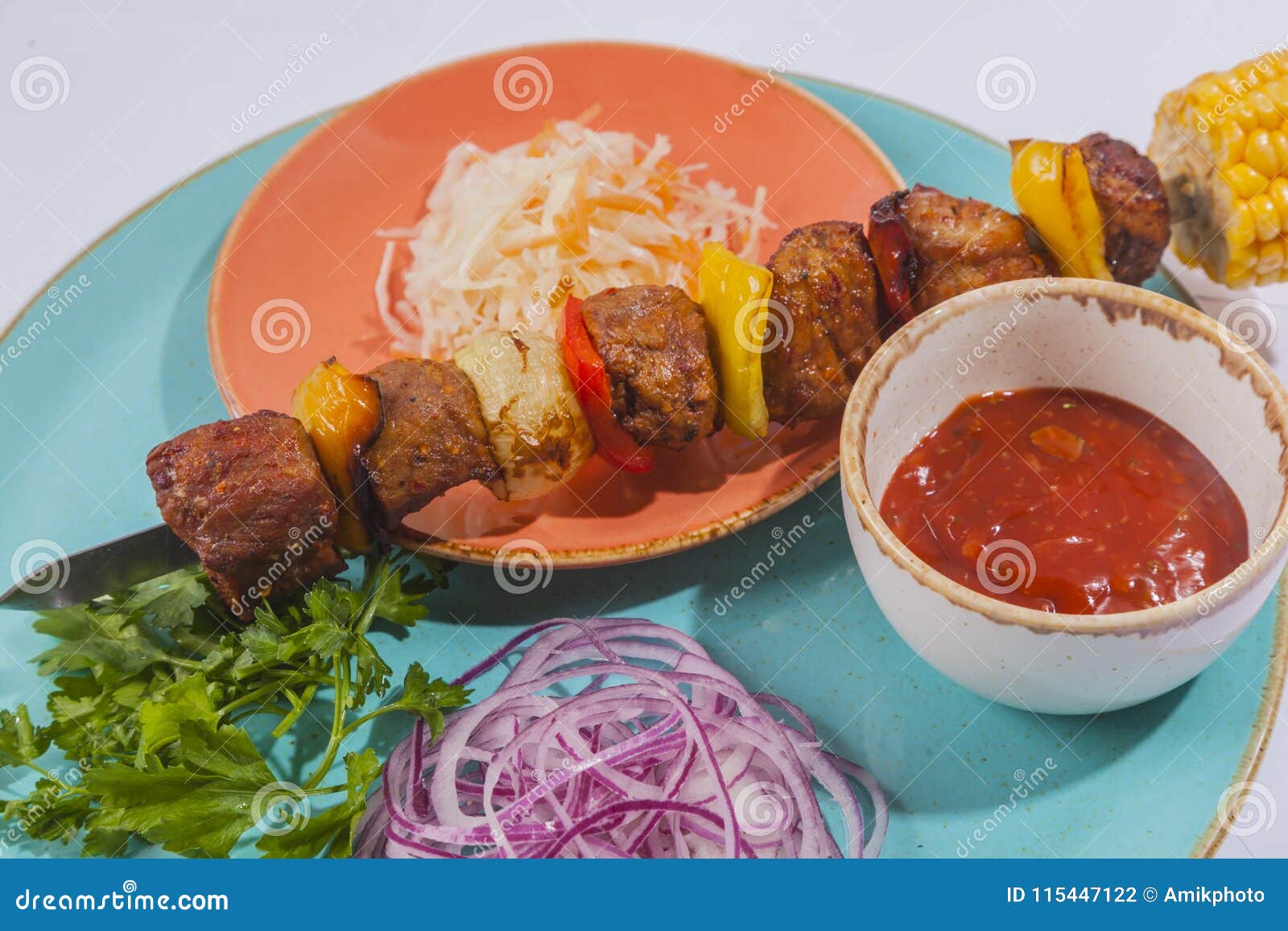 skewers with sauce and cabbage