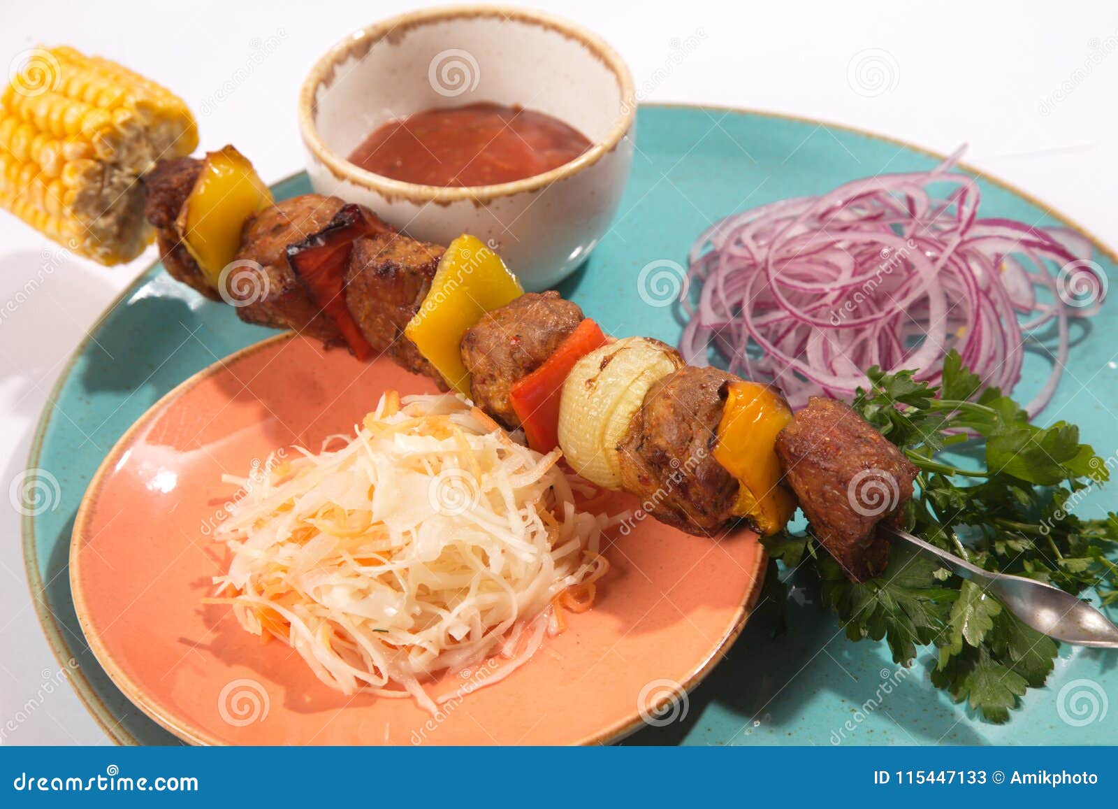 skewers with sauce and cabbage