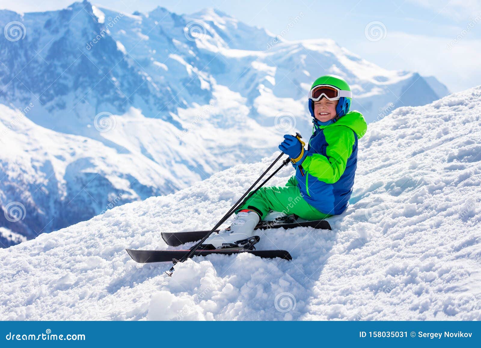Ski Boy Sit on Snow with Mountain Peak Background Stock Image - Image ...