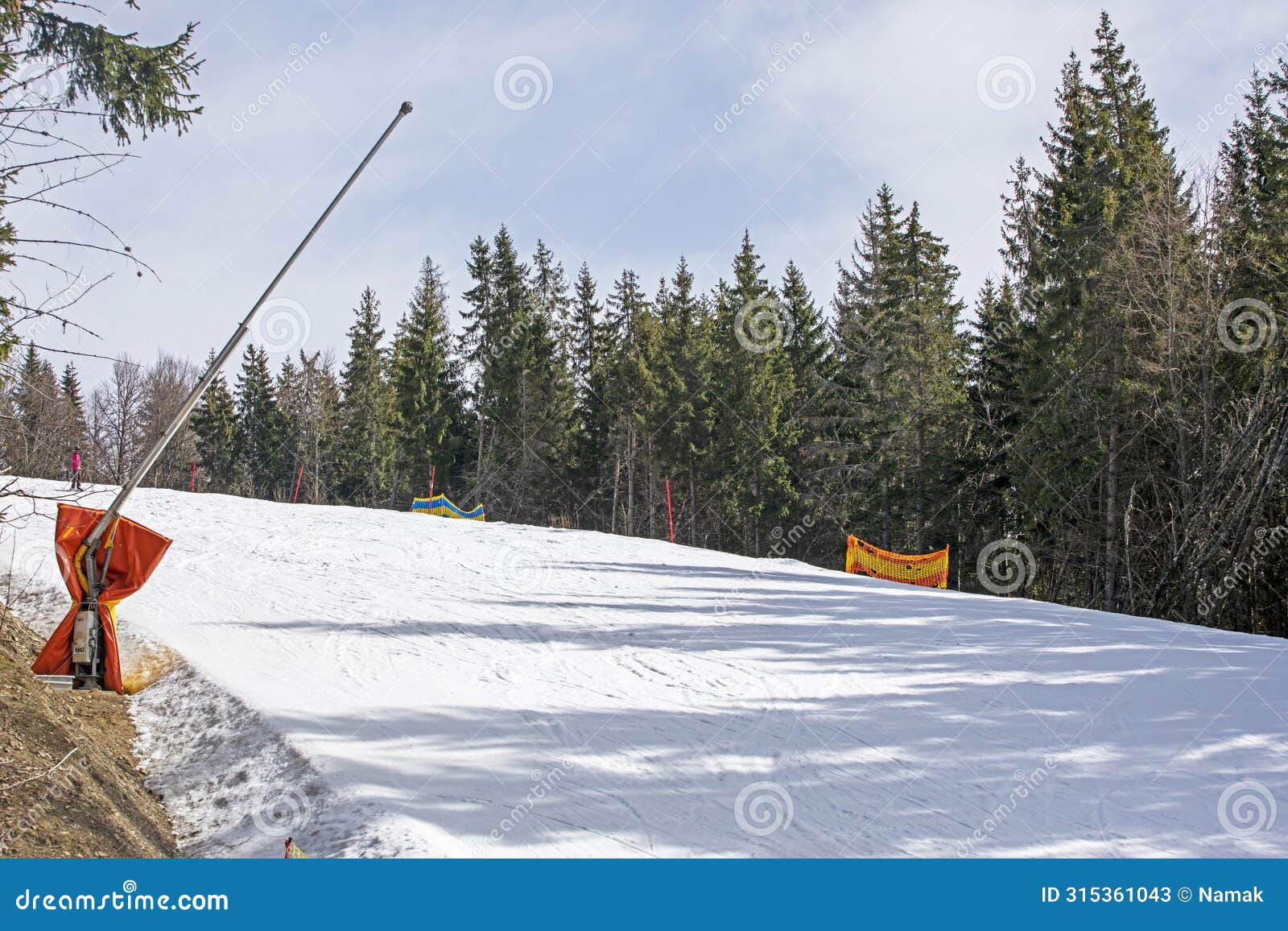 skiers on a snow slope for beginners on a sunny day.