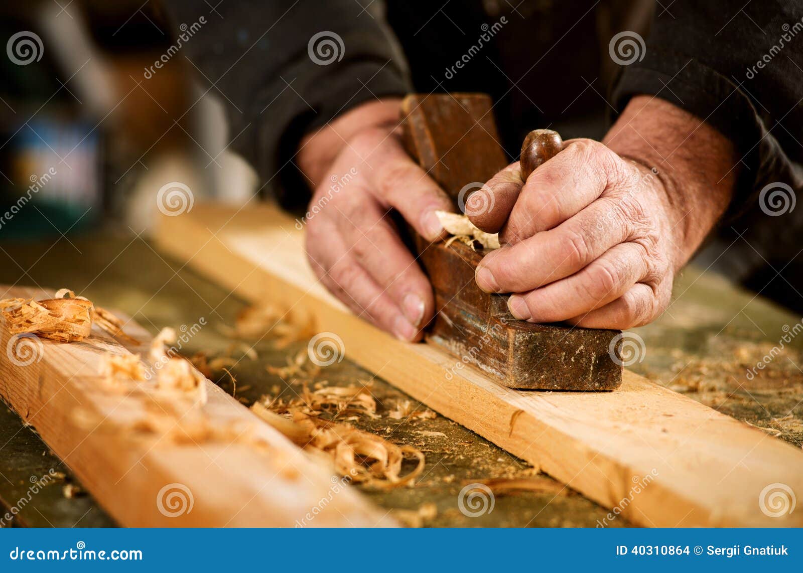 skilled carpenter using a handheld plane