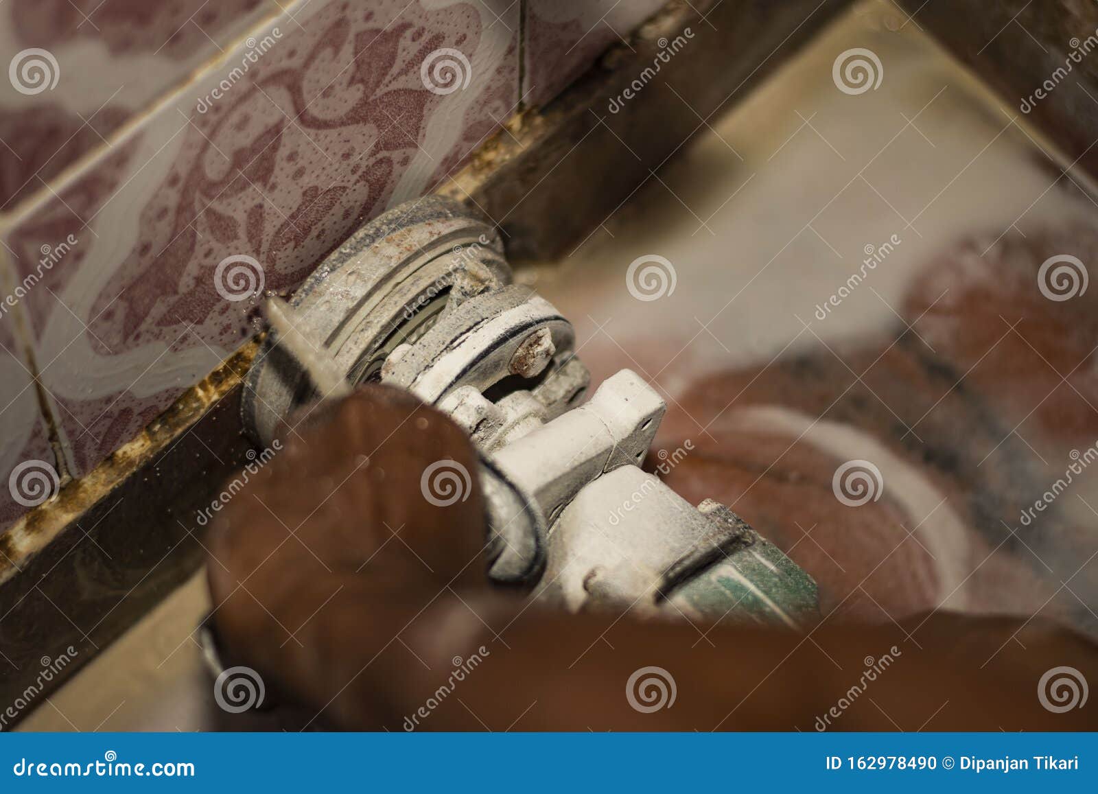 A Skilled Worker Cleaning The Bathroom Floor With A Machine Stock