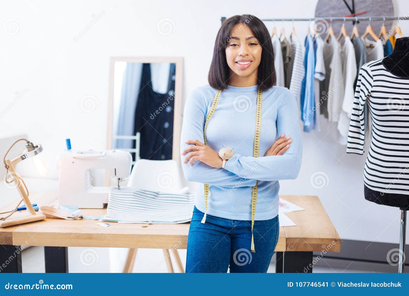 Skilled Young Worker Standing with Her Arms Crossed and Smiling Stock ...