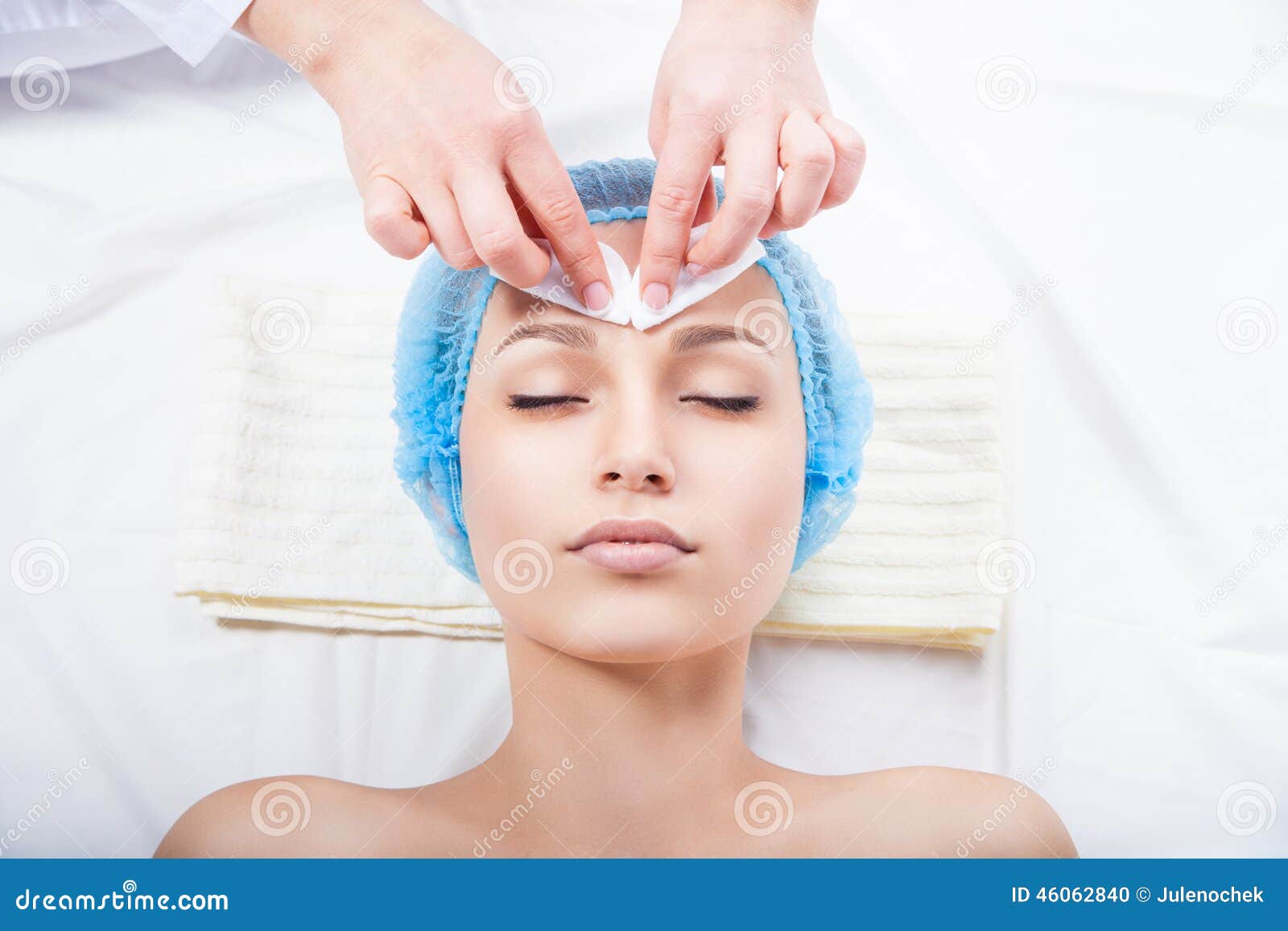 skin care - woman cleaning face by beautician