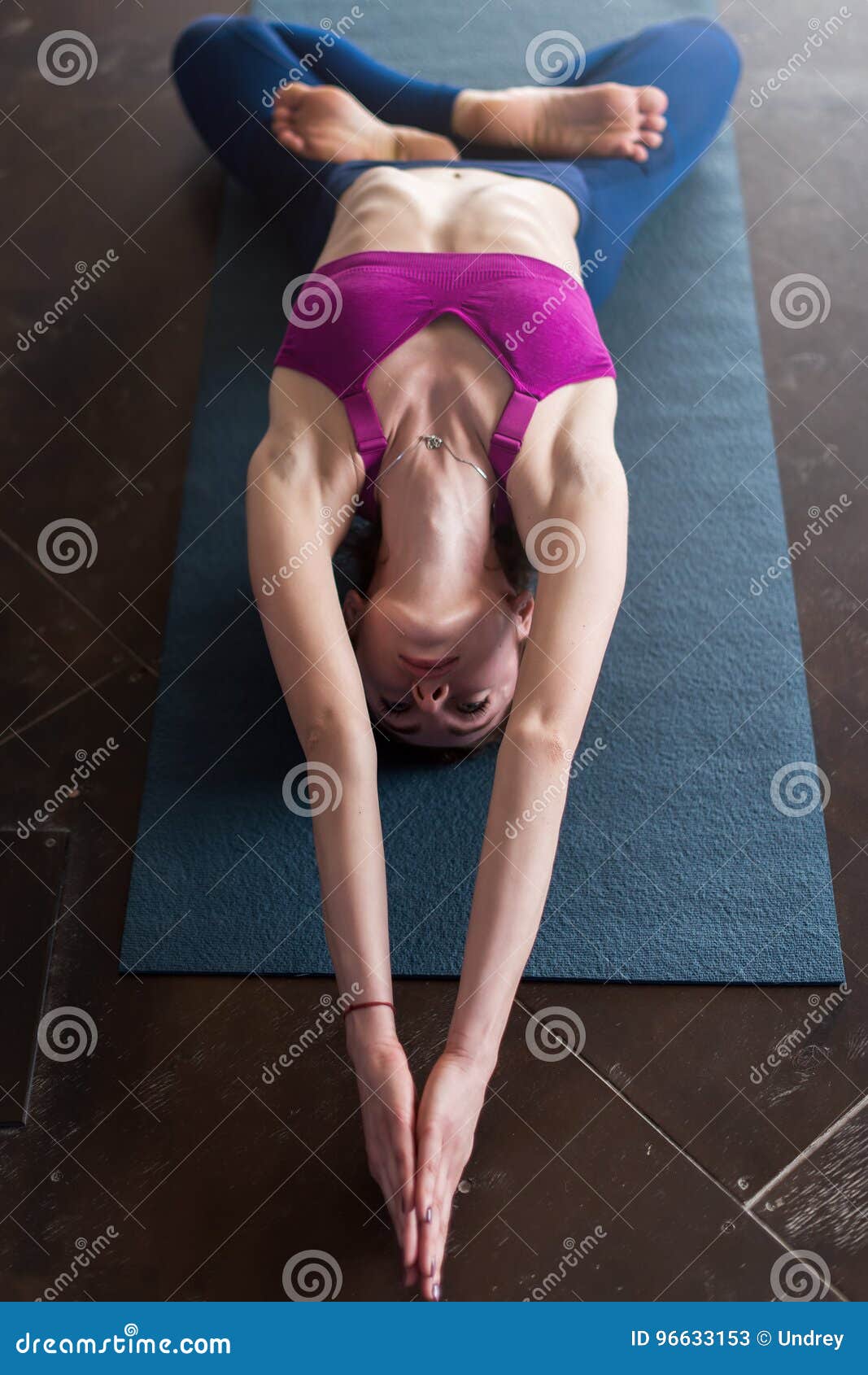 Skinny Girl in Sports Bra Doing Core Stretching Exercise with Back