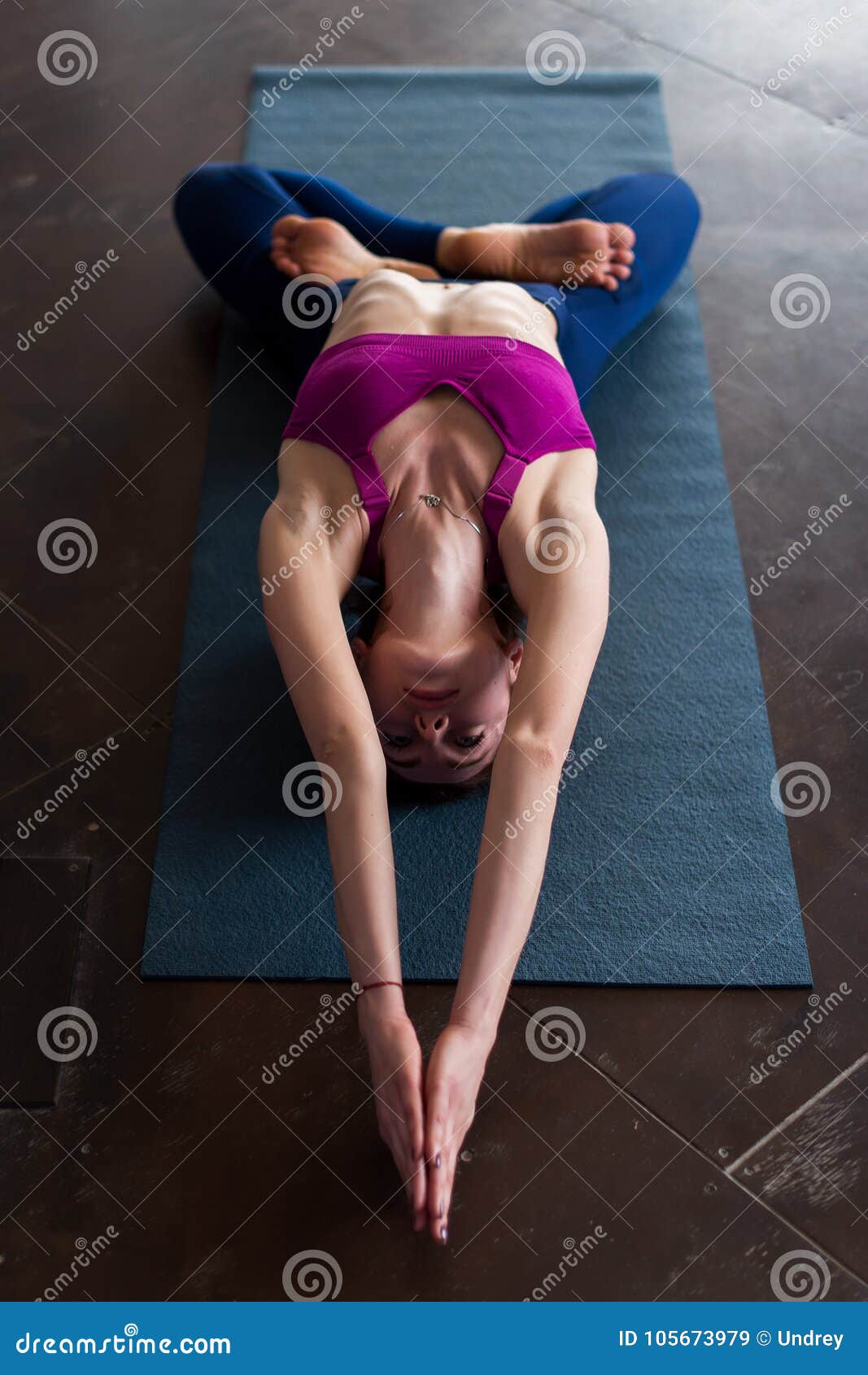 Skinny Girl in Sports Bra Doing Core Stretching Exercise with Back