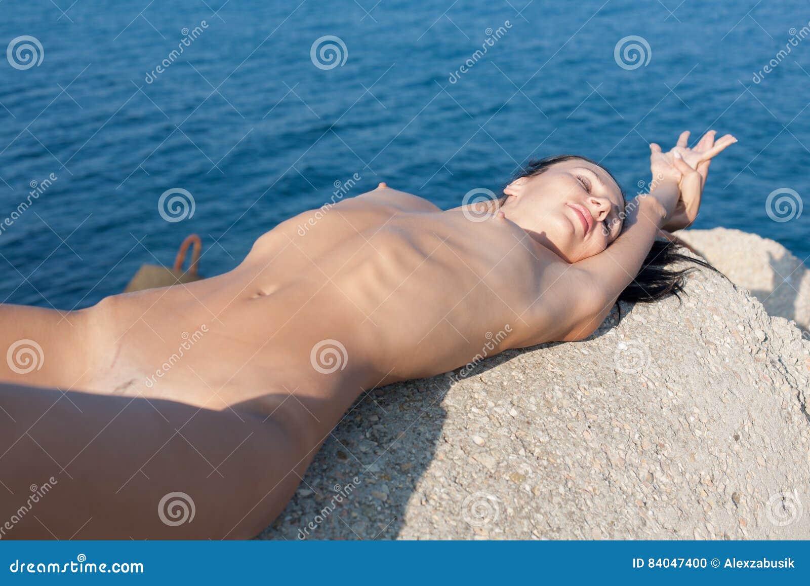 Skinny teen sunbathes in topless in HD video