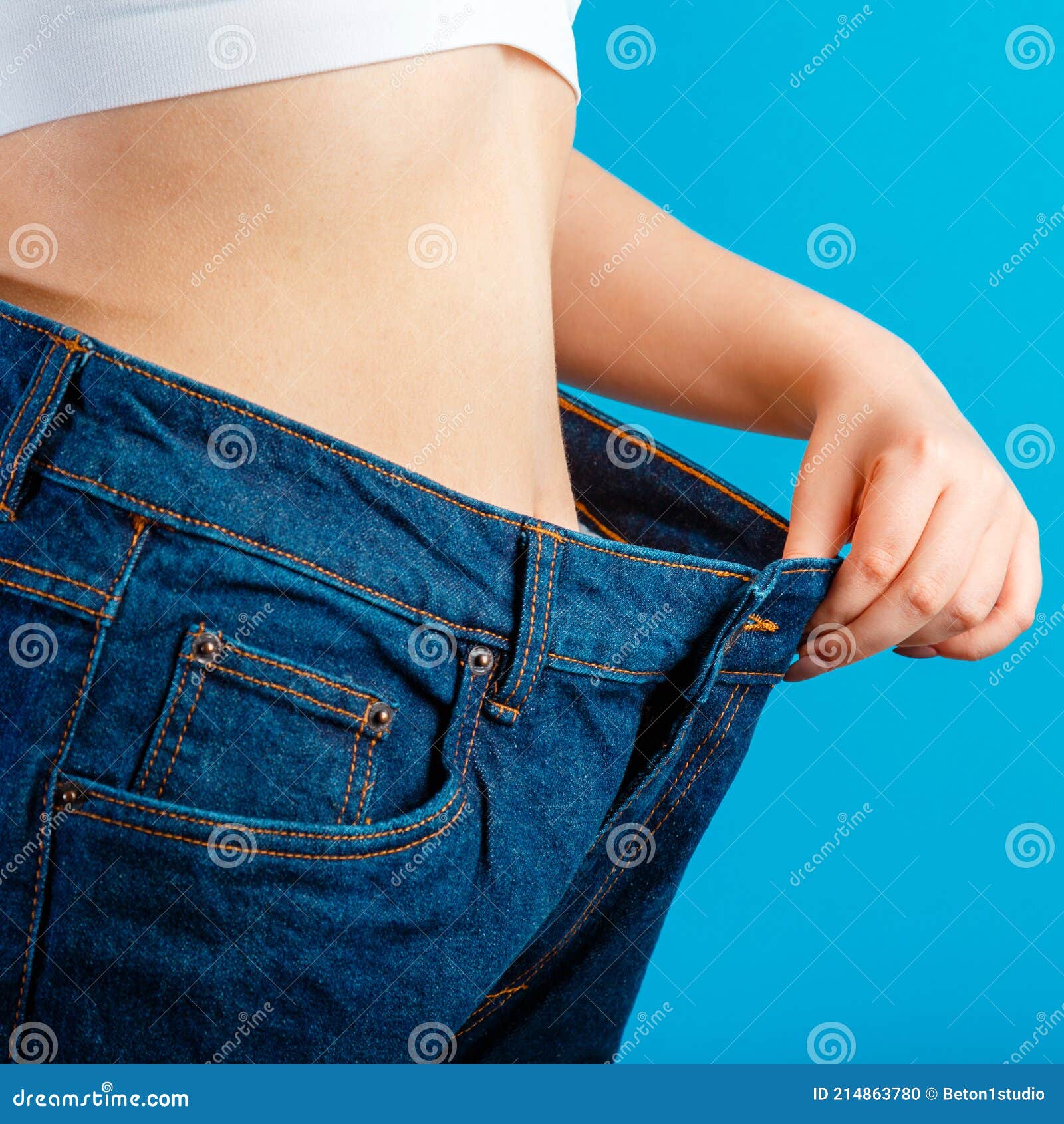 Skinny Weight Loss Woman Show Flat Stomach Pulling by Hand Oversized Big  Blue Pants Jeans. Slim Body Low Fat Healthy Size Athletic Stock Photo -  Image of large, body: 214863780