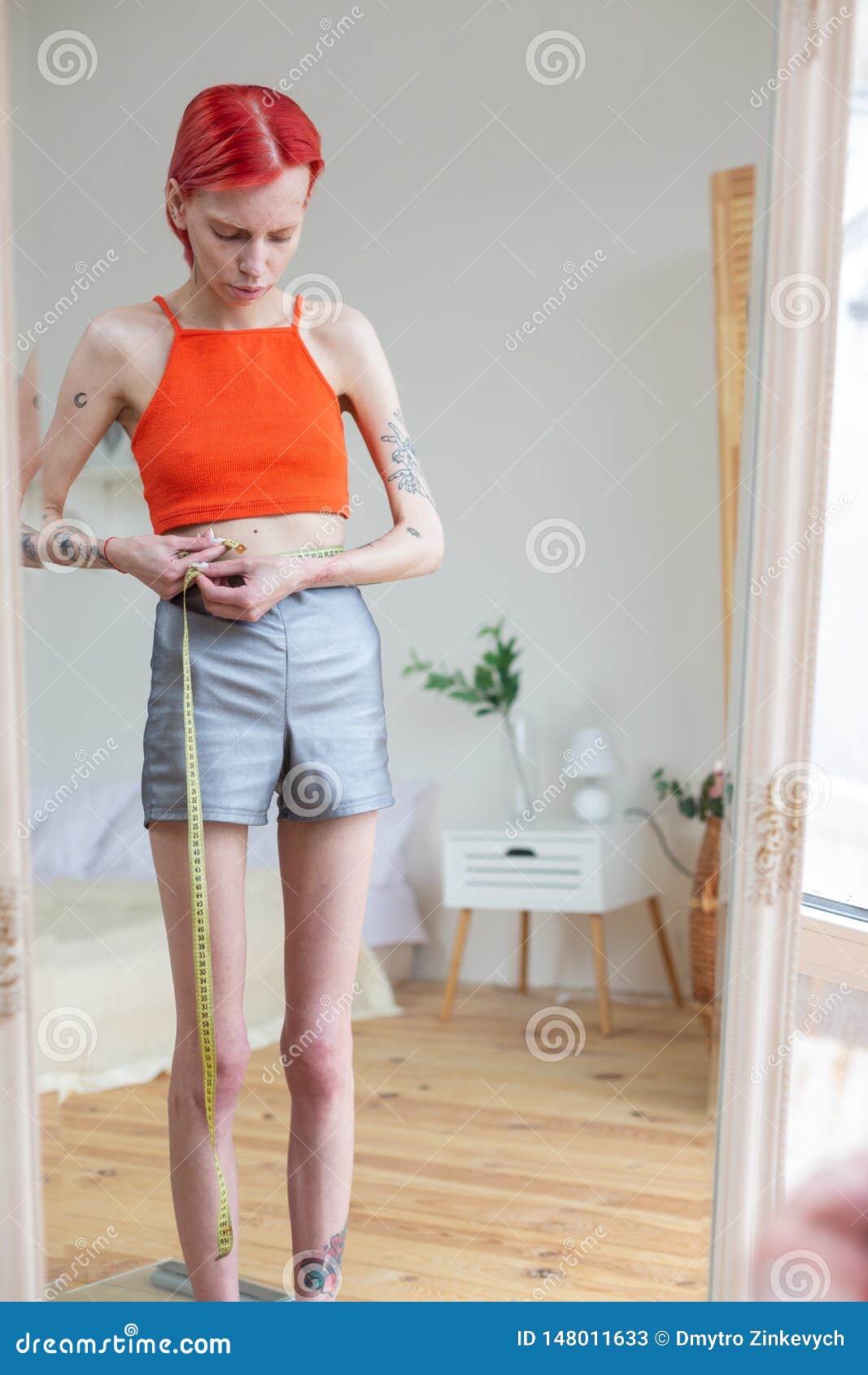 Skinny Woman Measuring Her Waistline With Tape Measure Stock Image